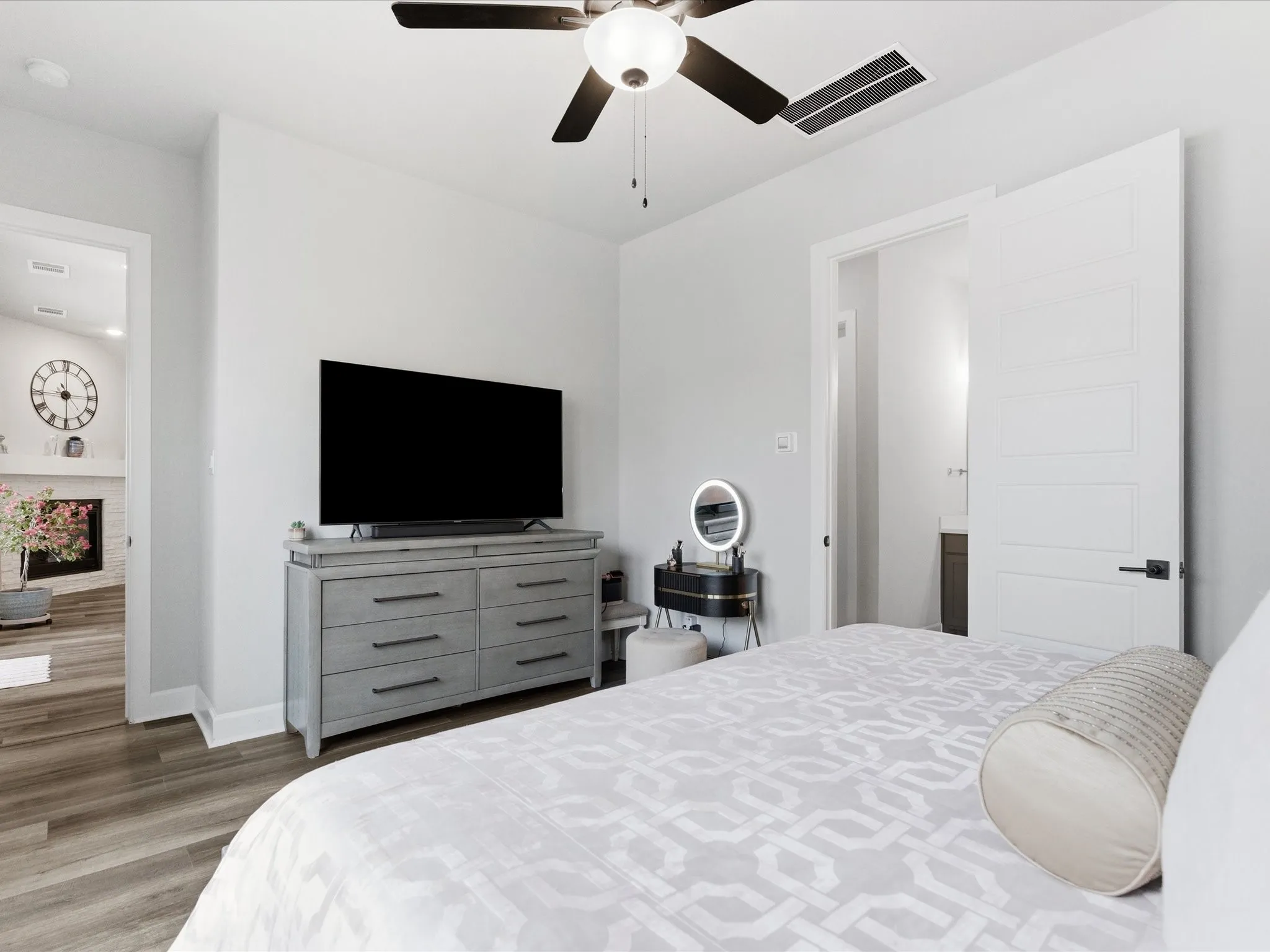 comfortable bedroom featuring a dedicated TV for entertainment, with a convenient view toward the private bathroom, creating a relaxing and functional retreat