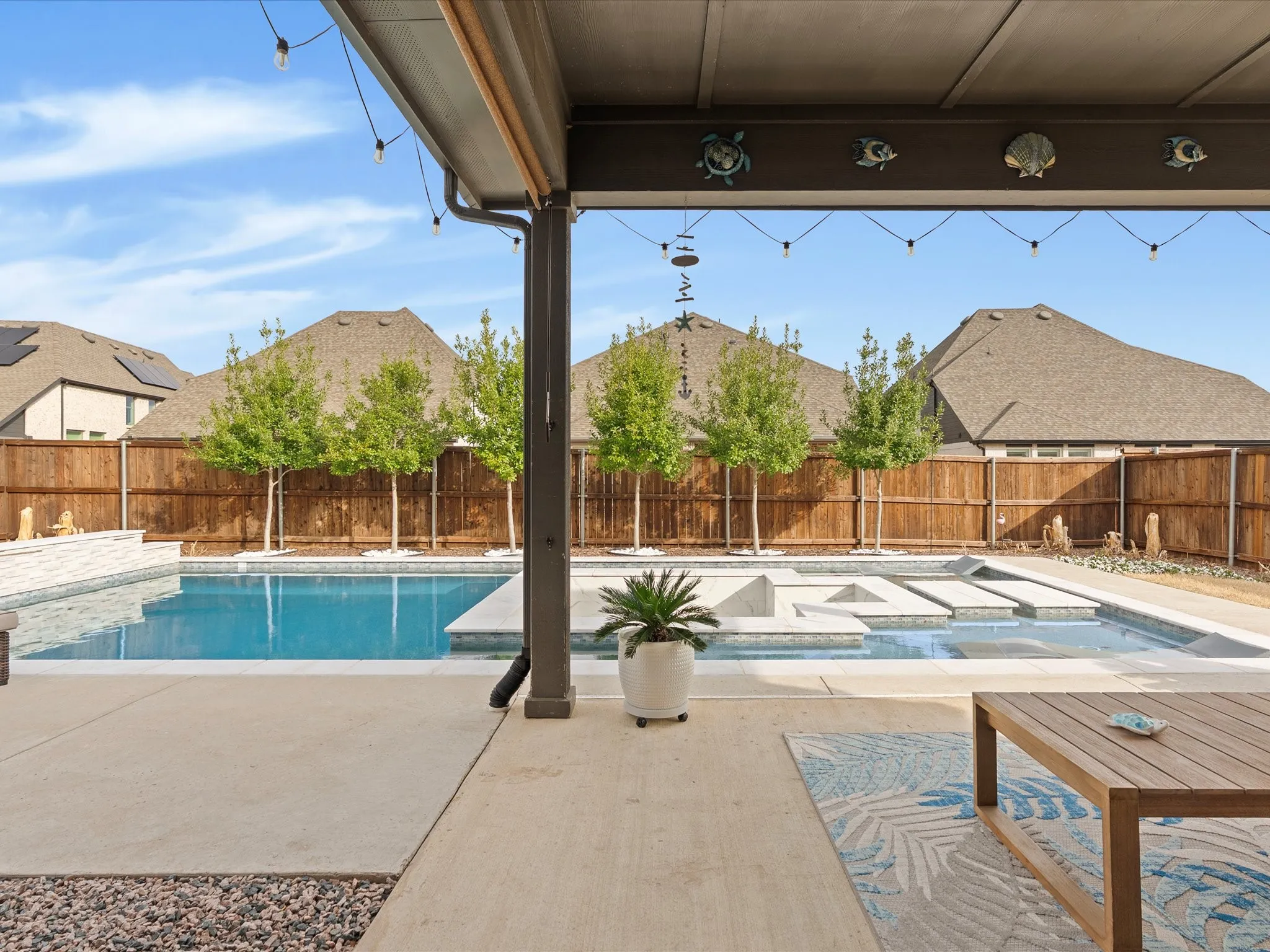 beautiful pool view overlooking the backyard, showcasing the sparkling water and inviting outdoor space from a relaxing perspective
