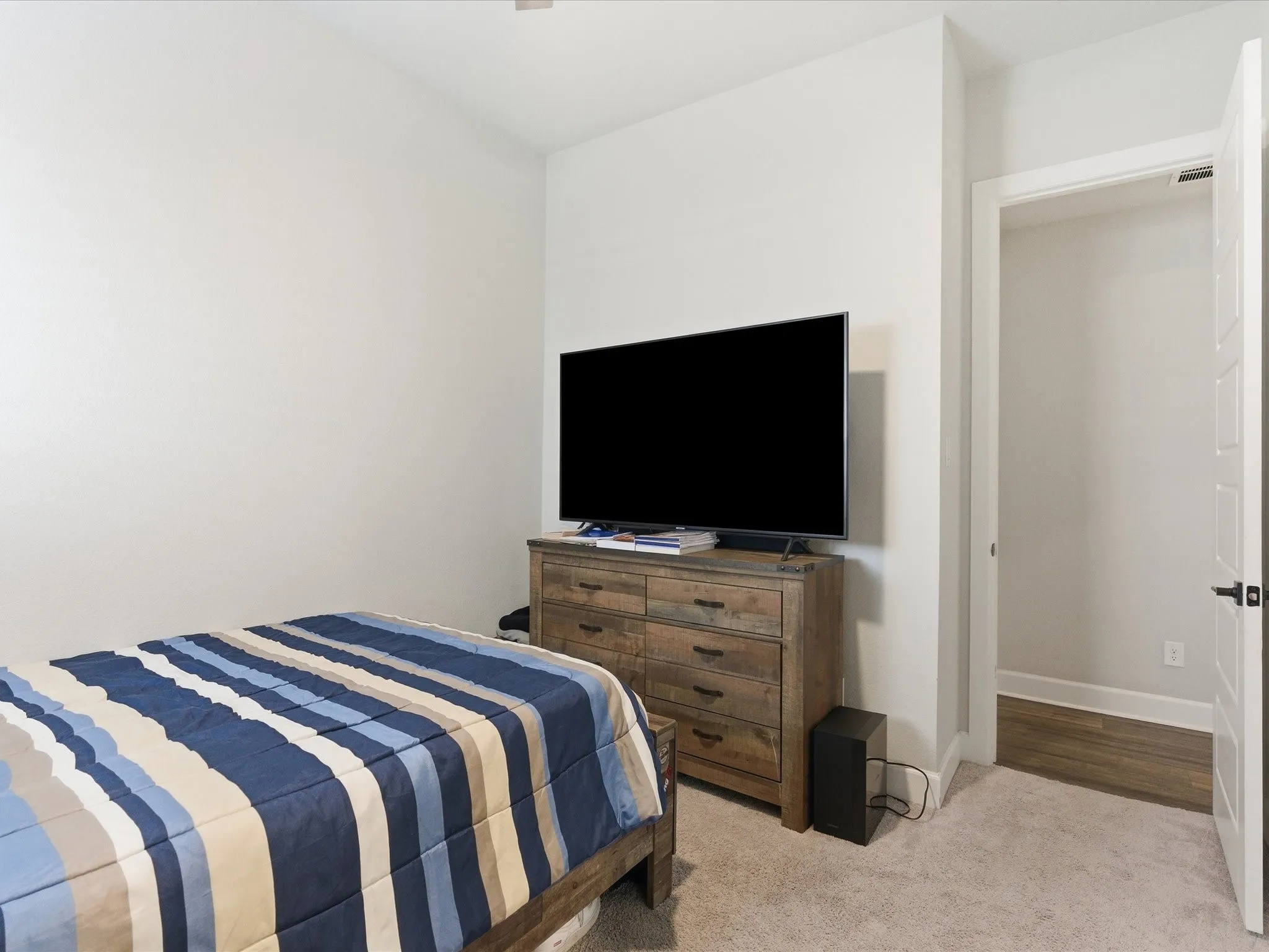 cozy bedroom with a laid-back feel, featuring a comfortable setup and a TV for easygoing evenings