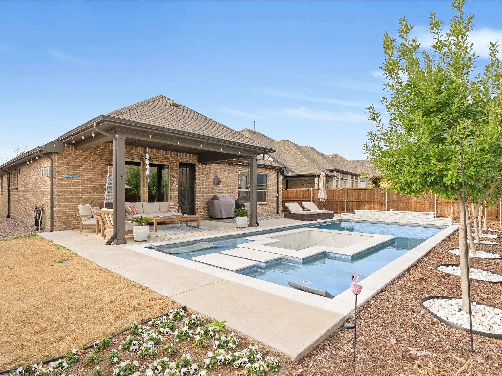 beautiful view of the backyard pool with the rear exterior of the home in the background, showcasing an inviting outdoor setting for relaxing and entertaining