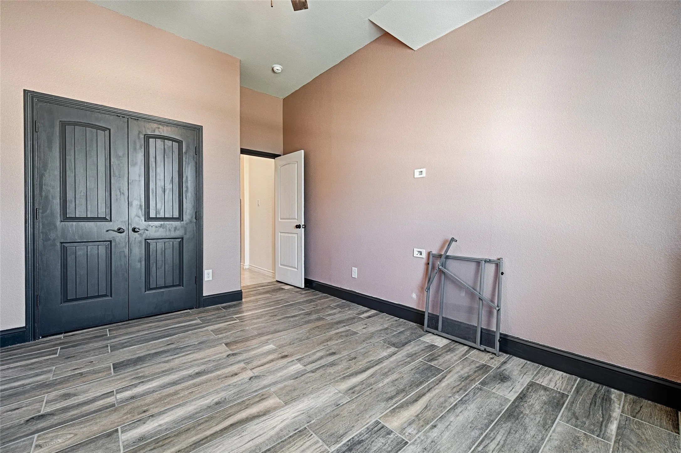 Unfurnished bedroom with ceiling fan, a closet, and wood-type flooring