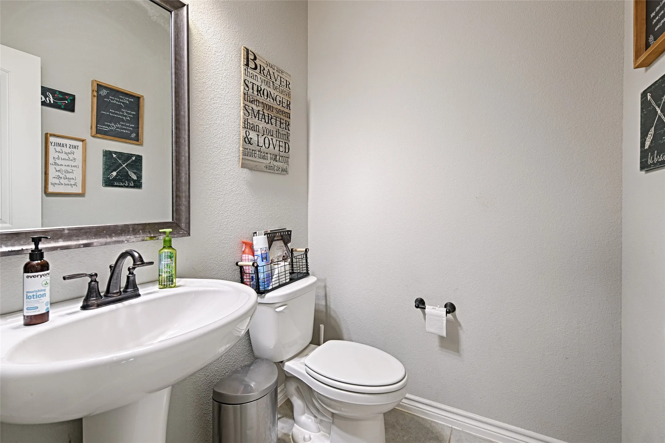 Bathroom featuring sink, tile flooring, and toilet