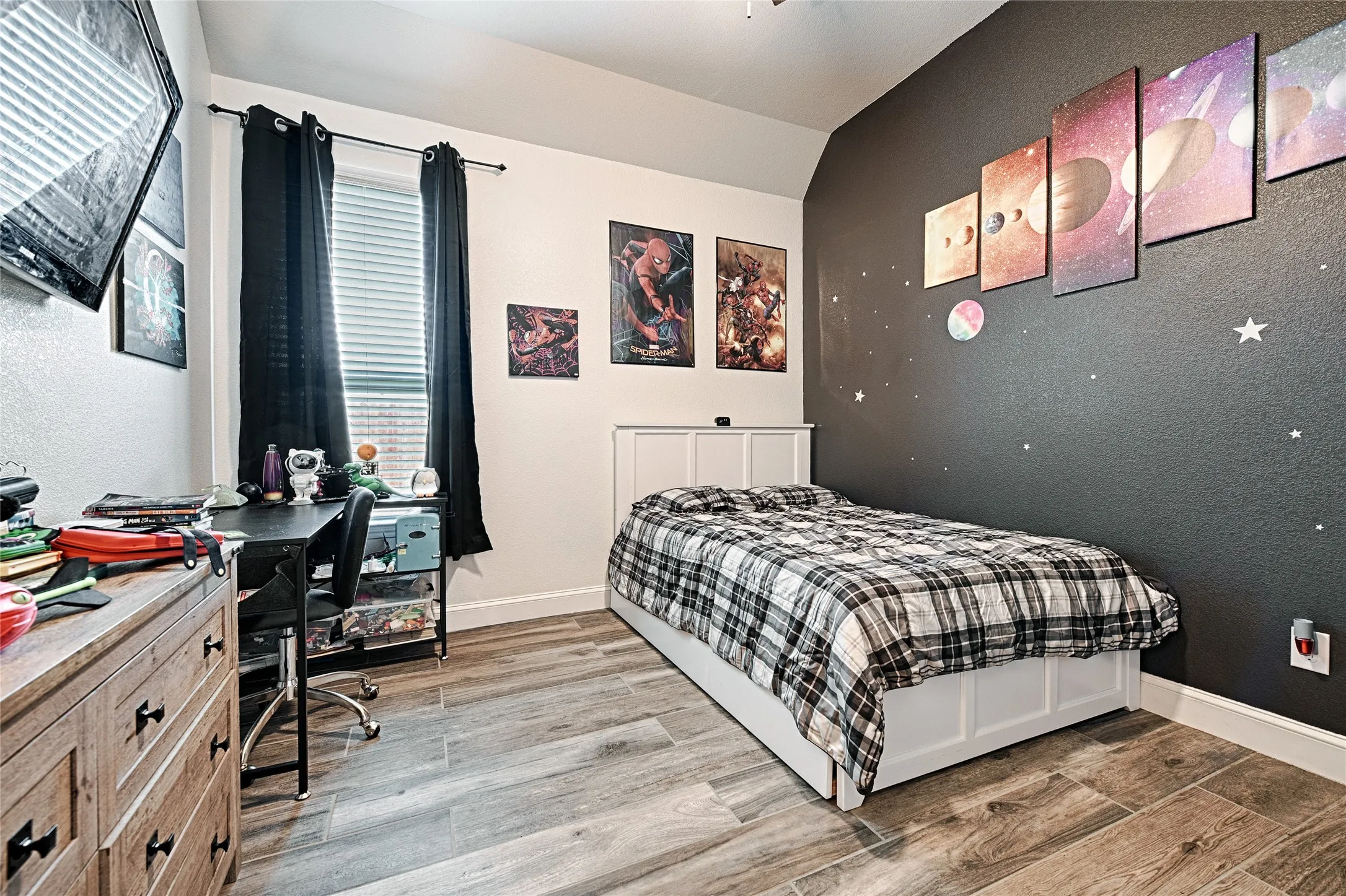 Bedroom with hardwood / wood-style floors and lofted ceiling