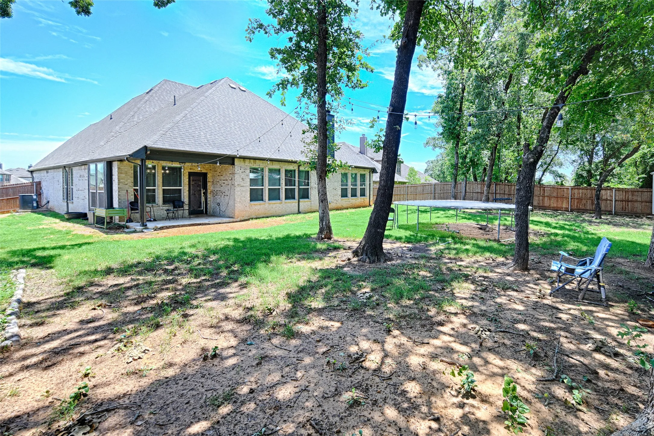 View of yard featuring a patio and central AC unit