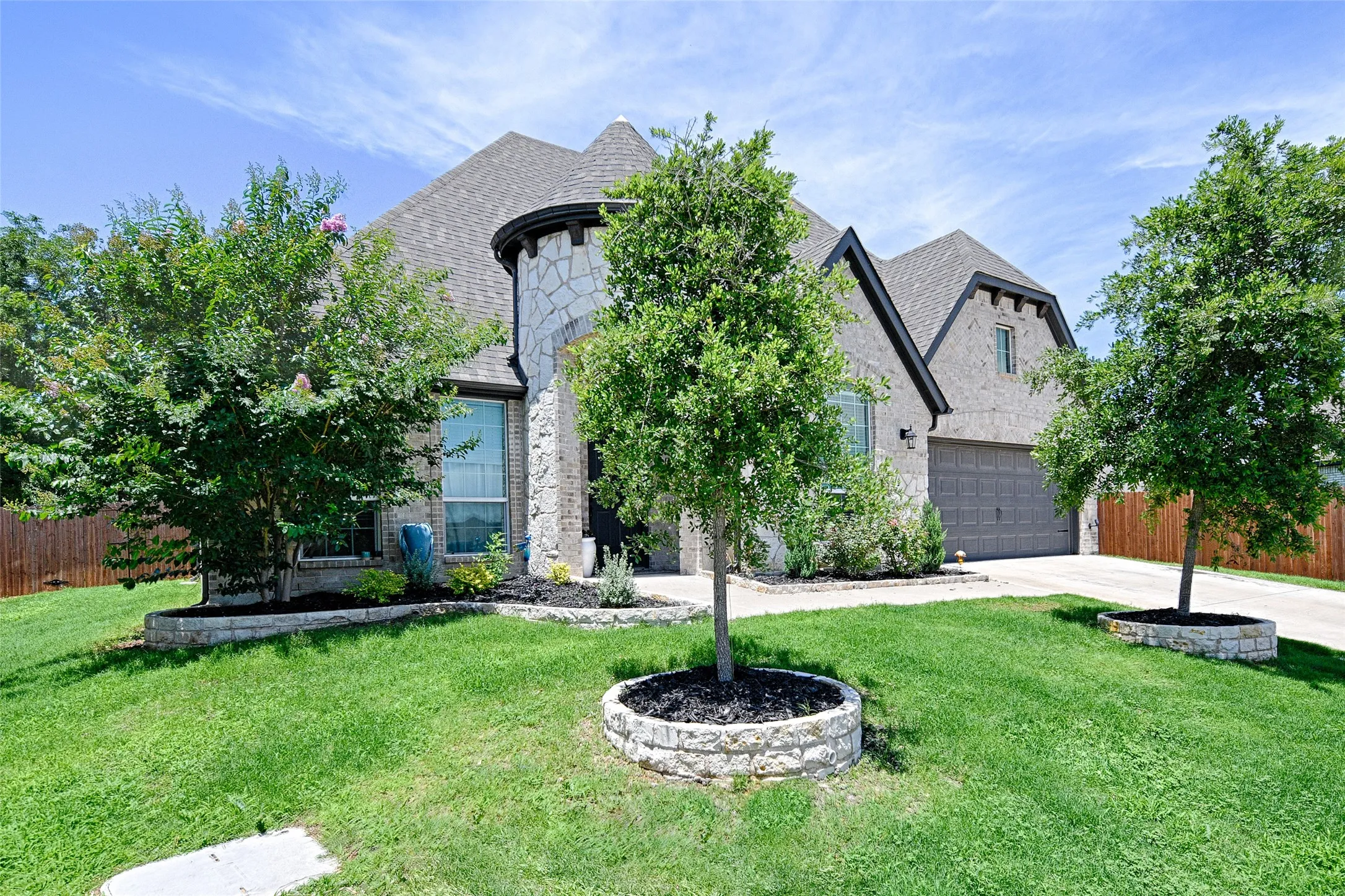 View of front of home with a front lawn and a garage