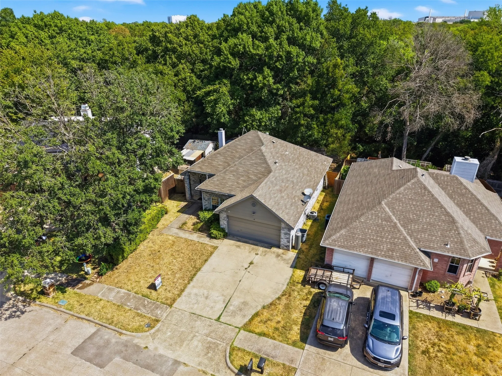 Single-story residence featuring a concrete driveway, attached garage, and a shingle roof