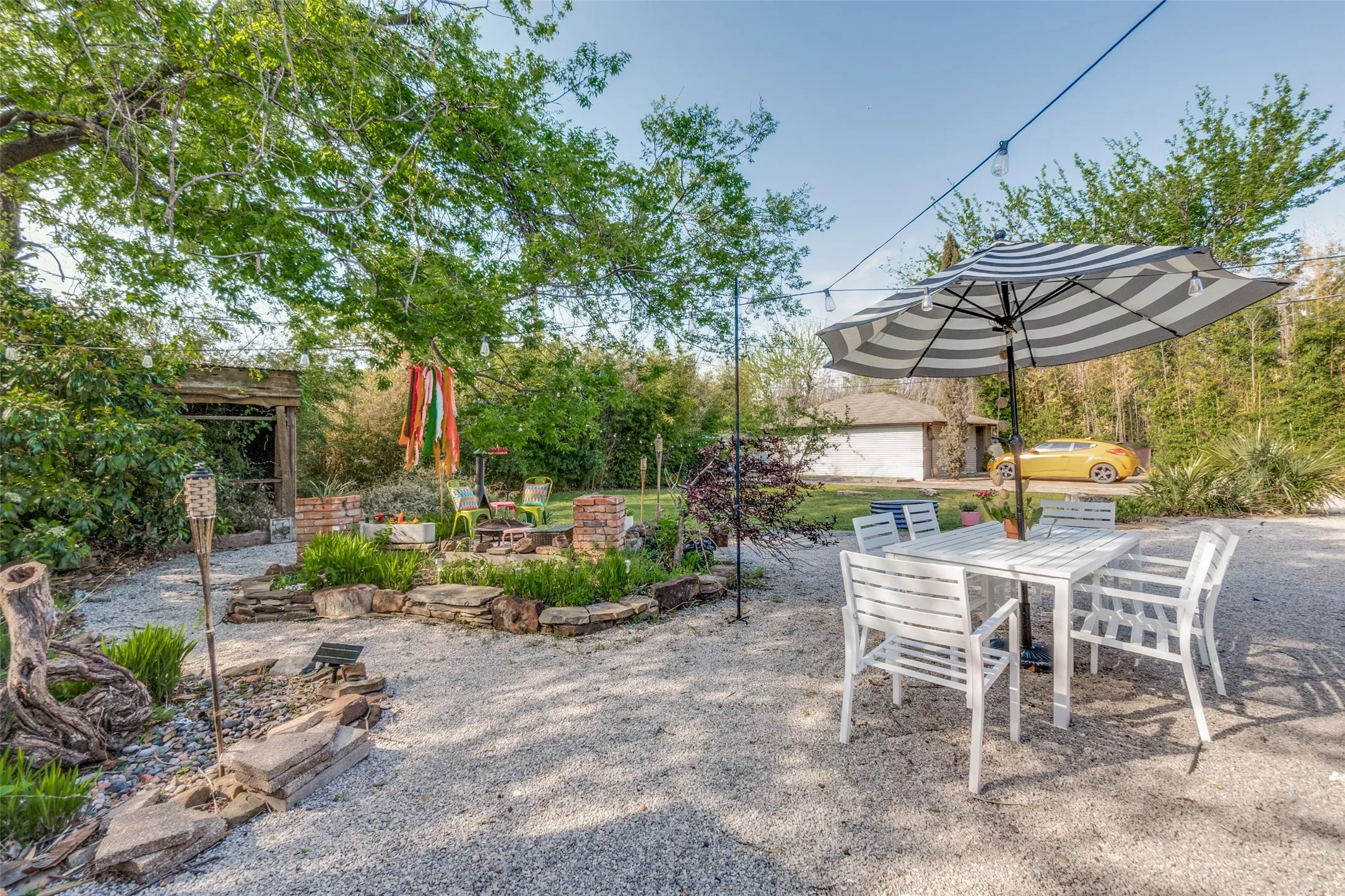 View of patio with an outbuilding, a fire pit, and outdoor dining space