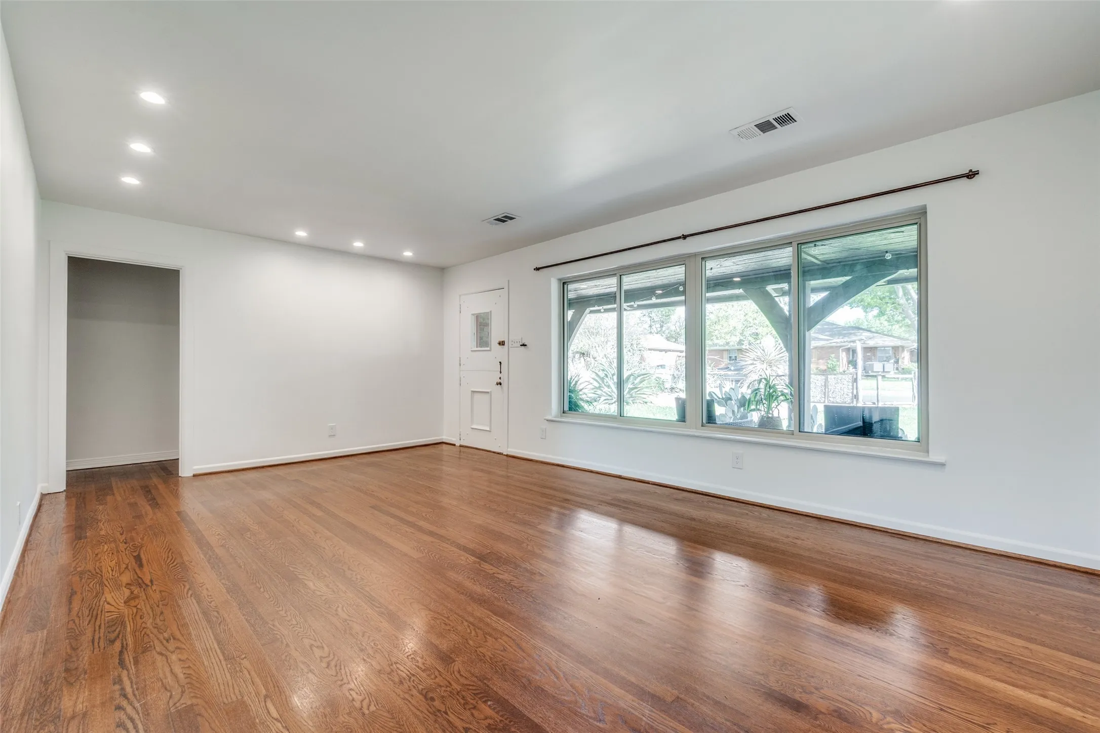 Spare room with visible vents, wood finished floors, and recessed lighting