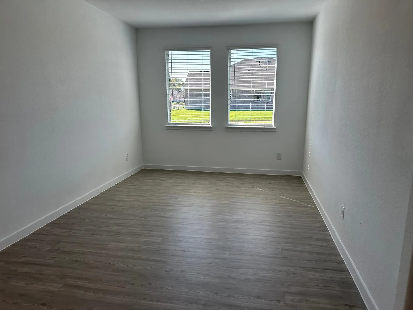 Spare room with dark hardwood / wood-style flooring