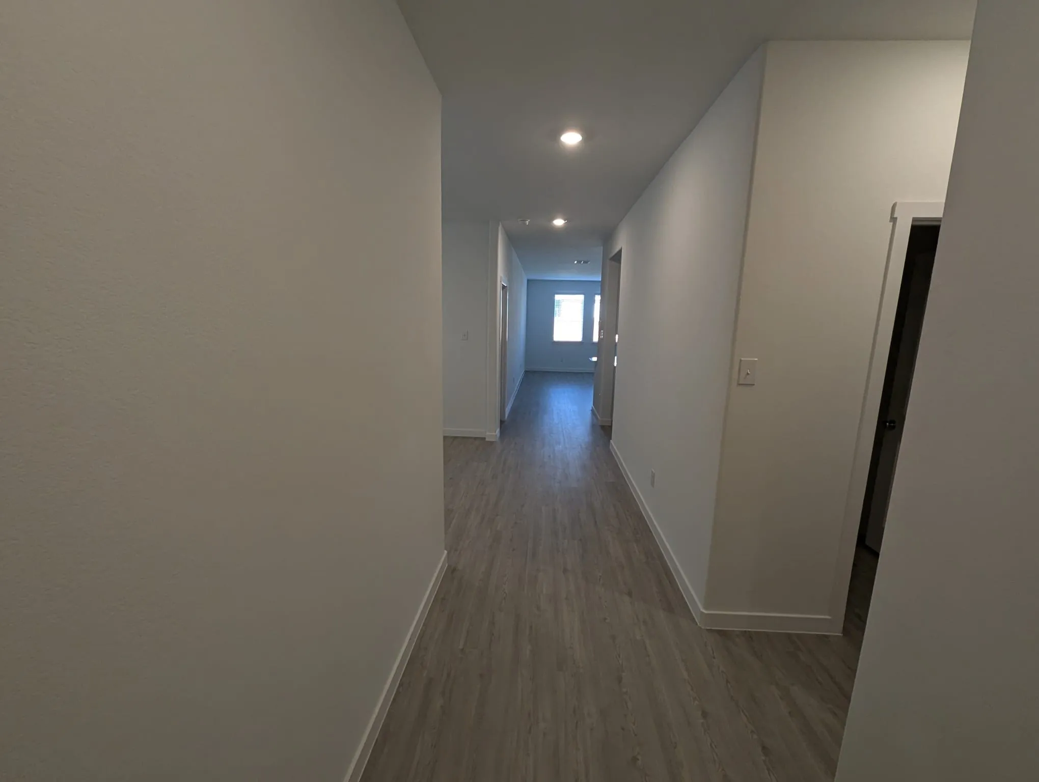 Corridor with light hardwood / wood-style flooring