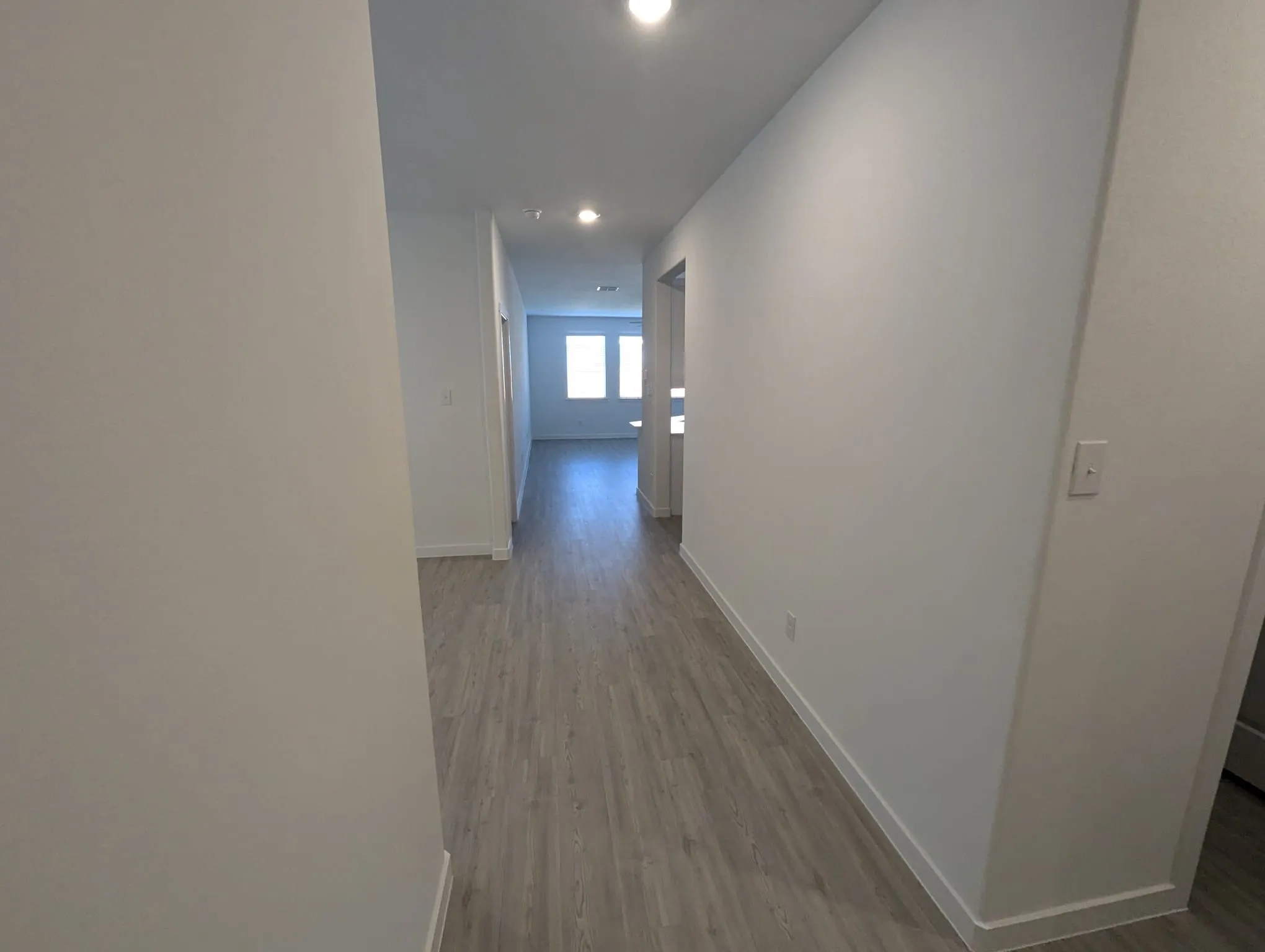 Corridor with light wood-type flooring