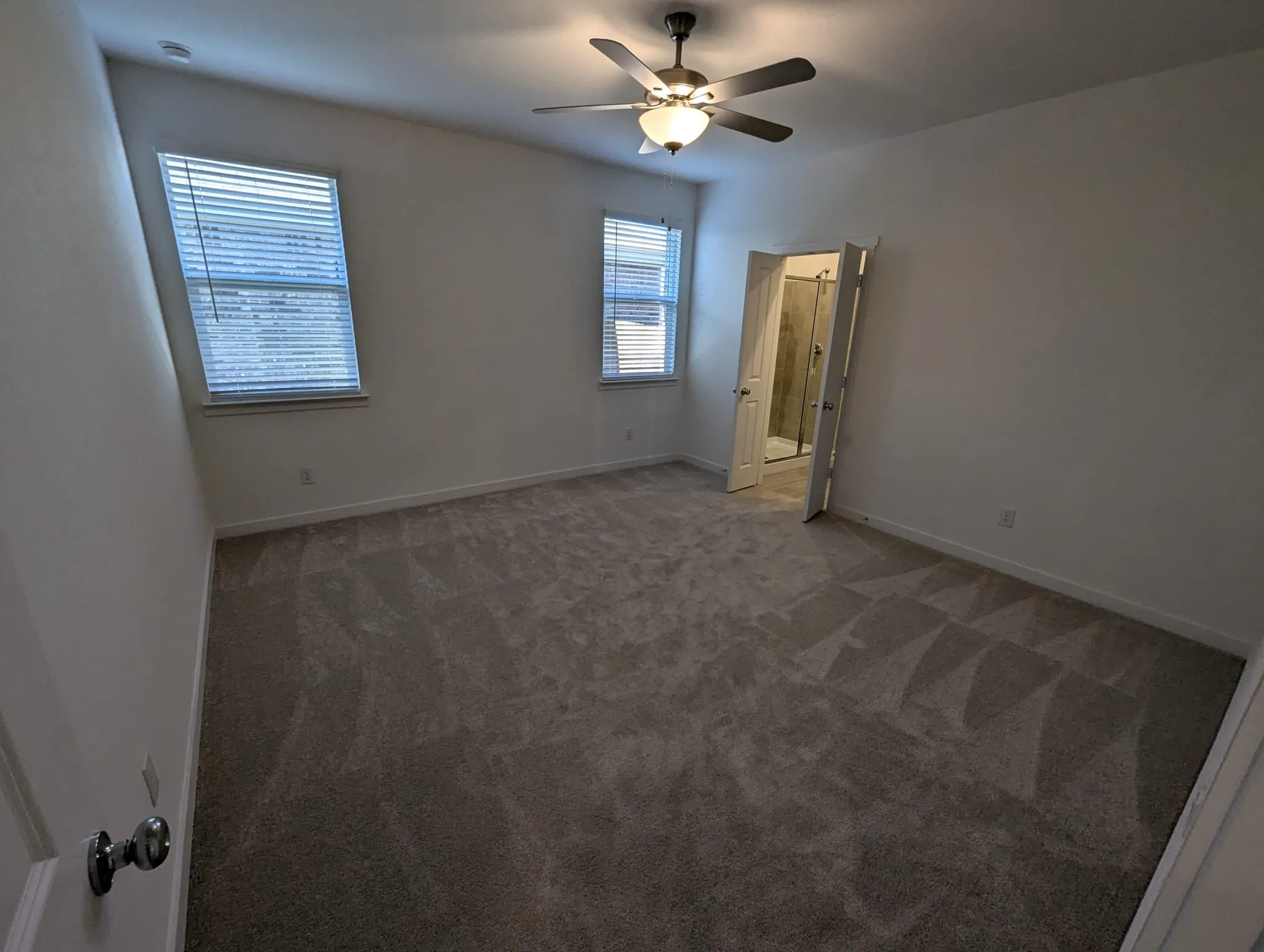 Unfurnished bedroom featuring ceiling fan and carpet