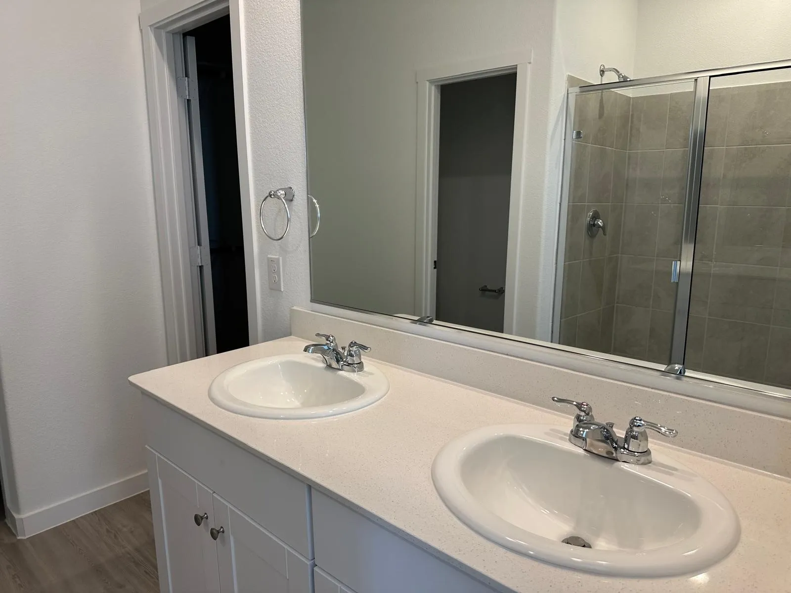 Bathroom featuring hardwood / wood-style floors, vanity, and walk in shower