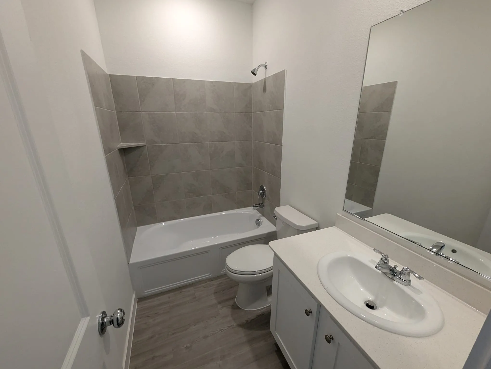 Full bathroom with toilet, hardwood / wood-style floors, vanity, and tiled shower / bath