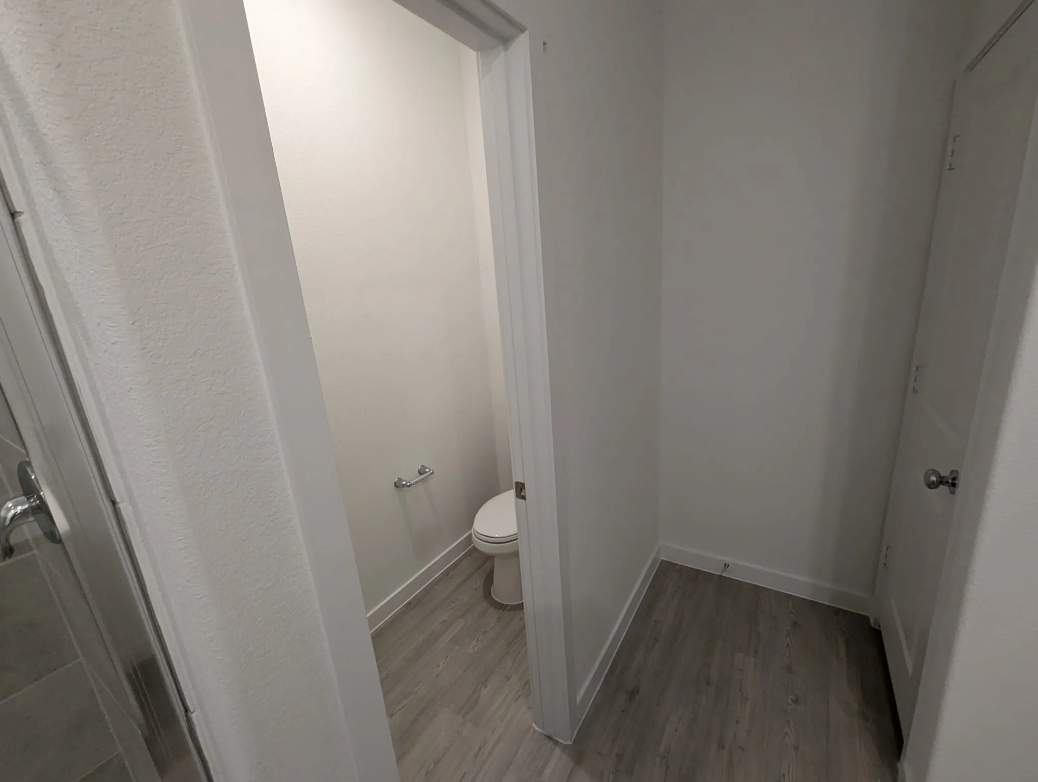 Bathroom with toilet and wood-type flooring
