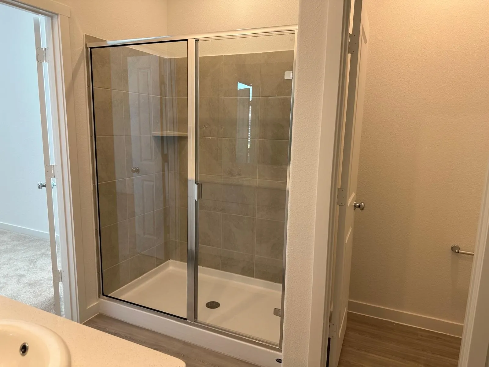 Bathroom featuring vanity, an enclosed shower, and wood-type flooring