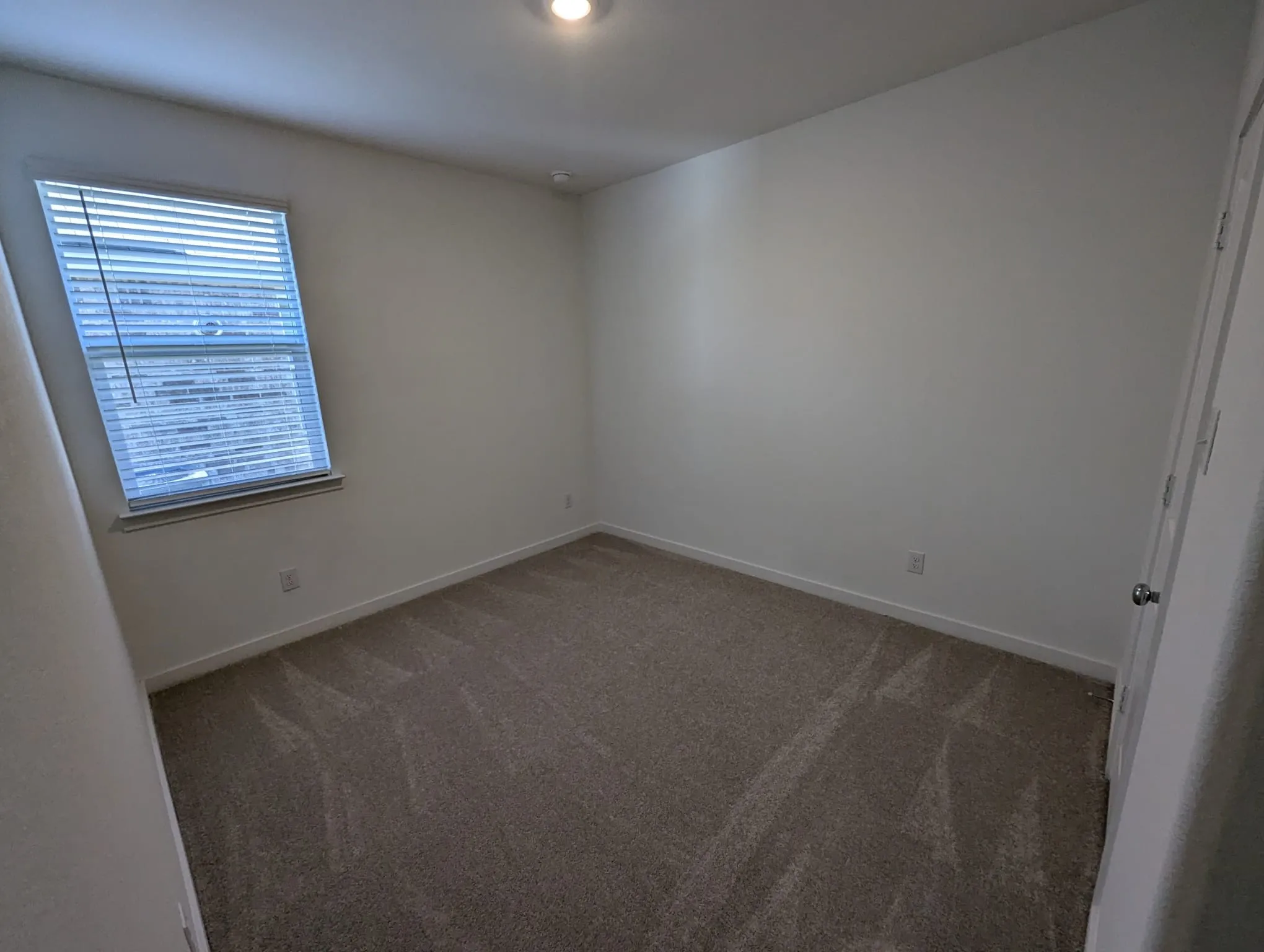 Spare room featuring dark carpet