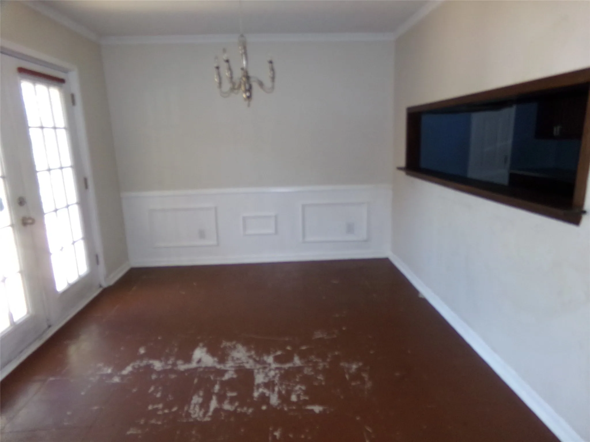 White wainscoting and crown molding accent the walls