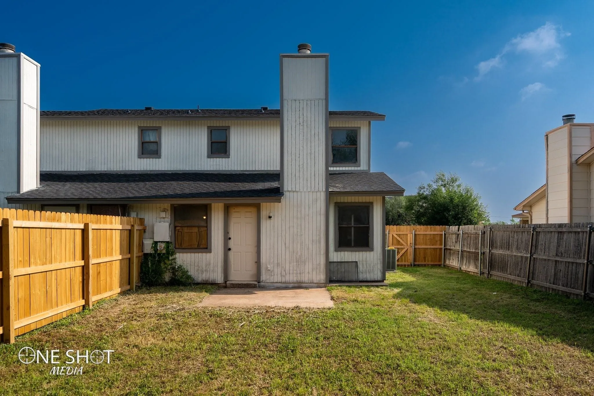 Rear view of property with cooling unit and a yard