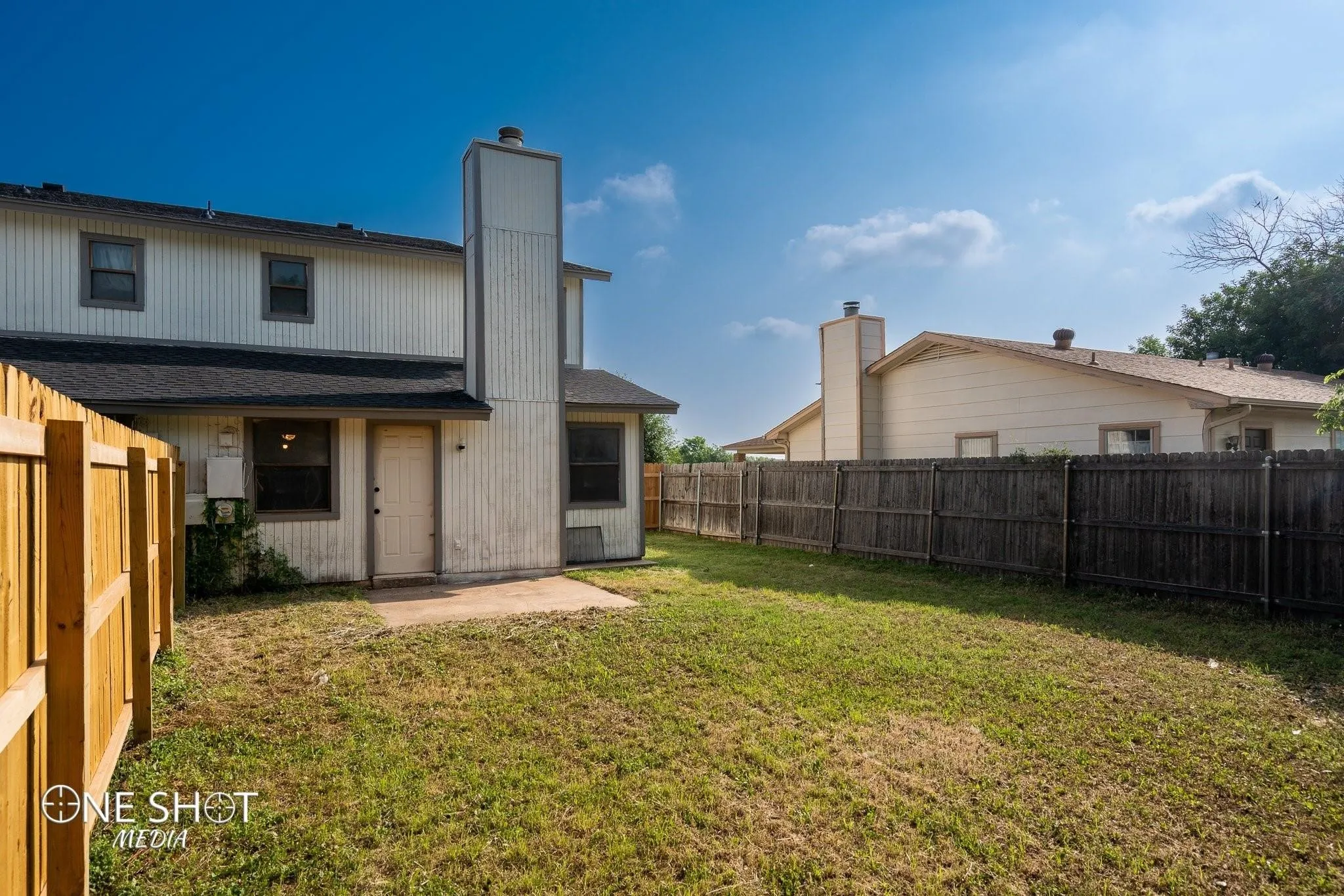 Rear view of house featuring a yard