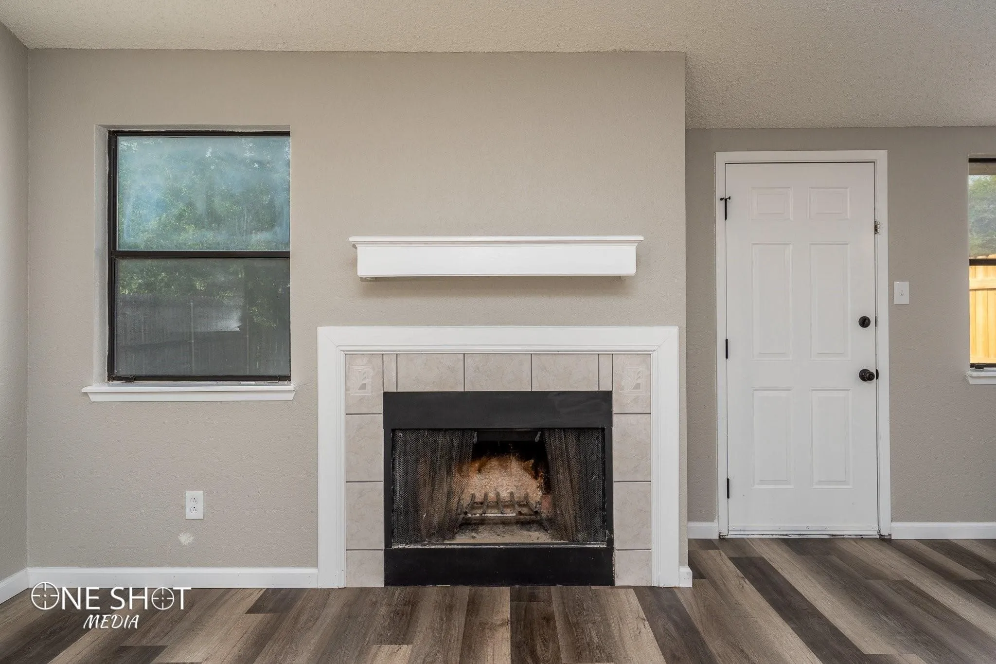 Interior details featuring a fireplace, hardwood / wood-style floors, and a textured ceiling