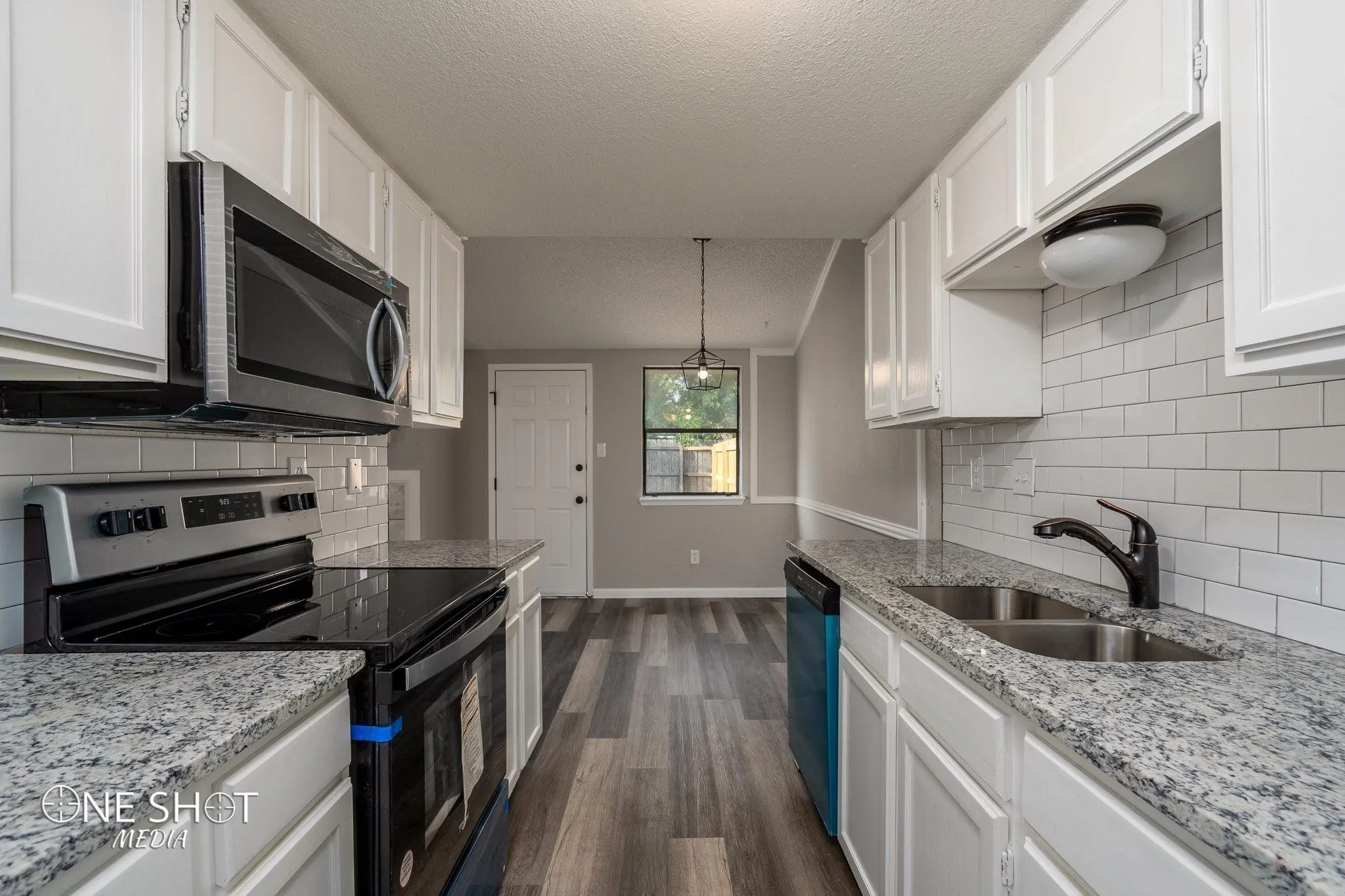 Kitchen featuring white cabinetry, stainless steel appliances, backsplash, and dark hardwood / wood-style flooring