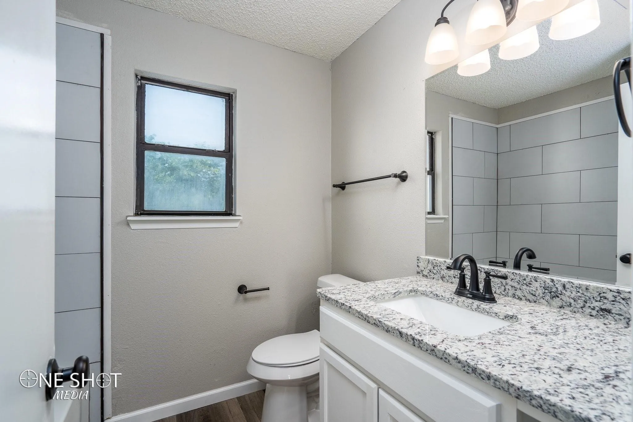 Bathroom with vanity, a textured ceiling, toilet, and hardwood / wood-style floors