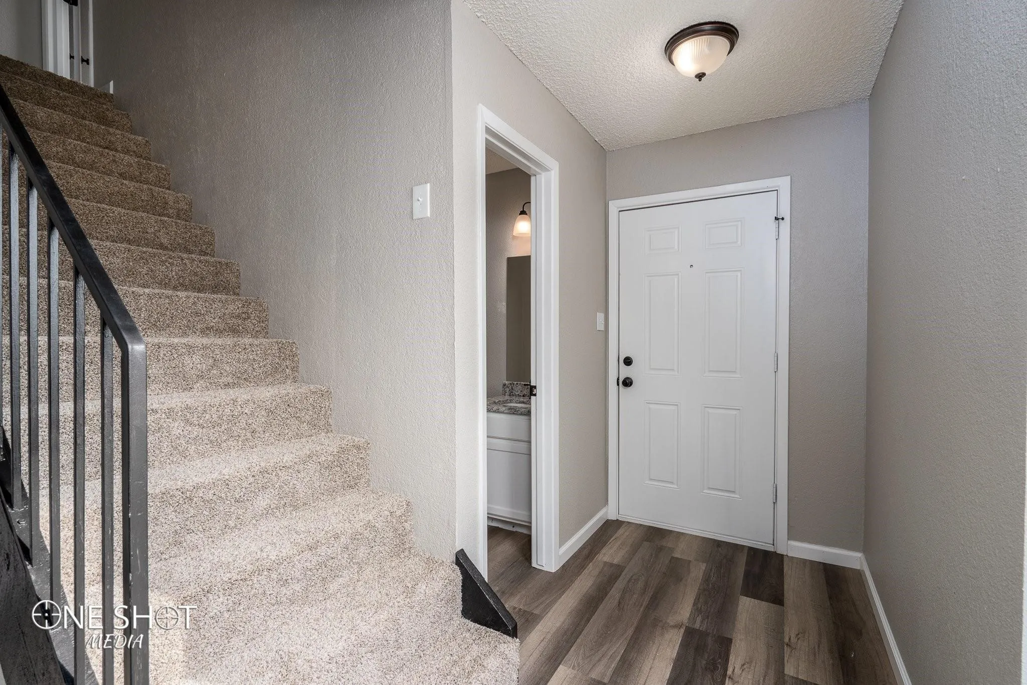 Entryway featuring a textured ceiling and wood-type flooring