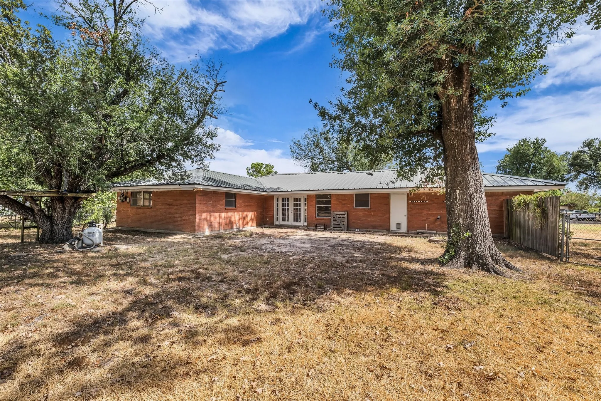French doors lead out to the back yard, with plenty of space for a large patio and garden shed.