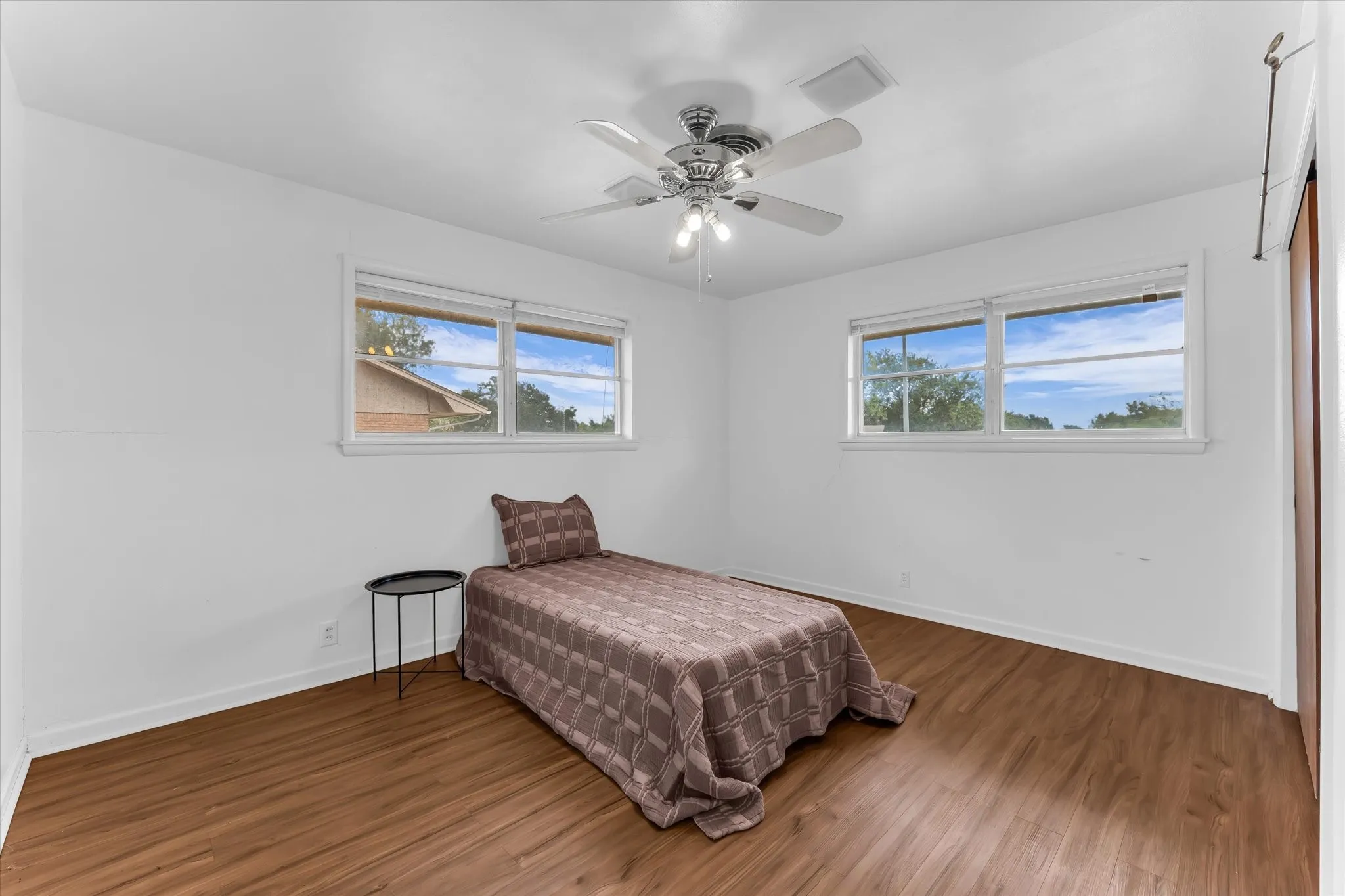 The front bedroom features windows on two walls, low maintenance hard flooring, and plenty of space to accommodate large furniture.