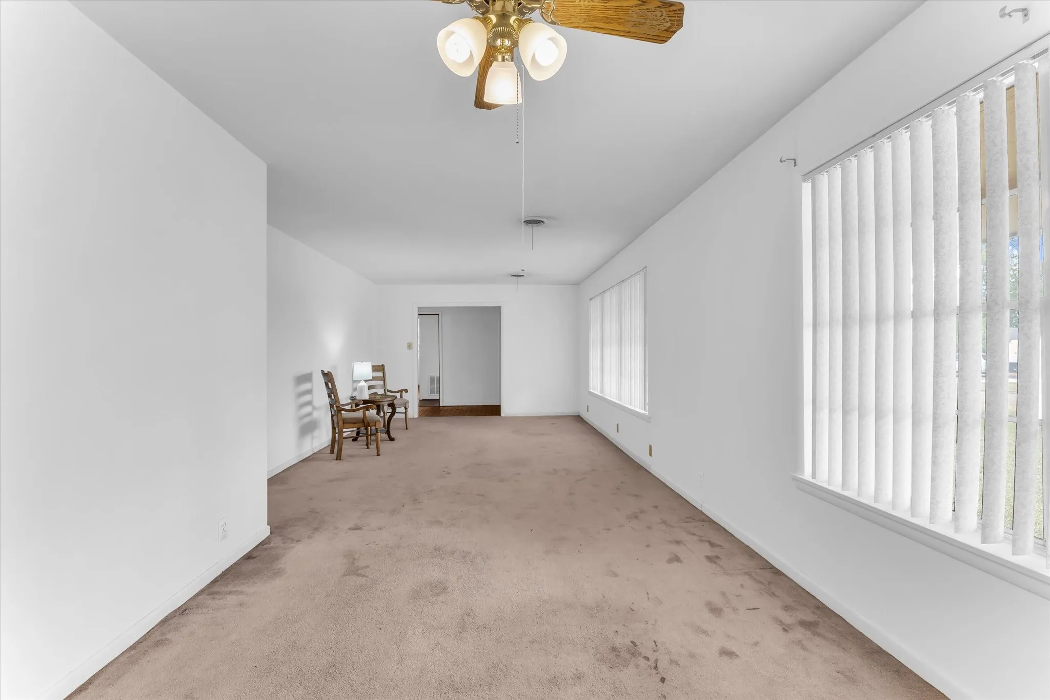 Formal living and dining area feature large windows and beautiful natural light.