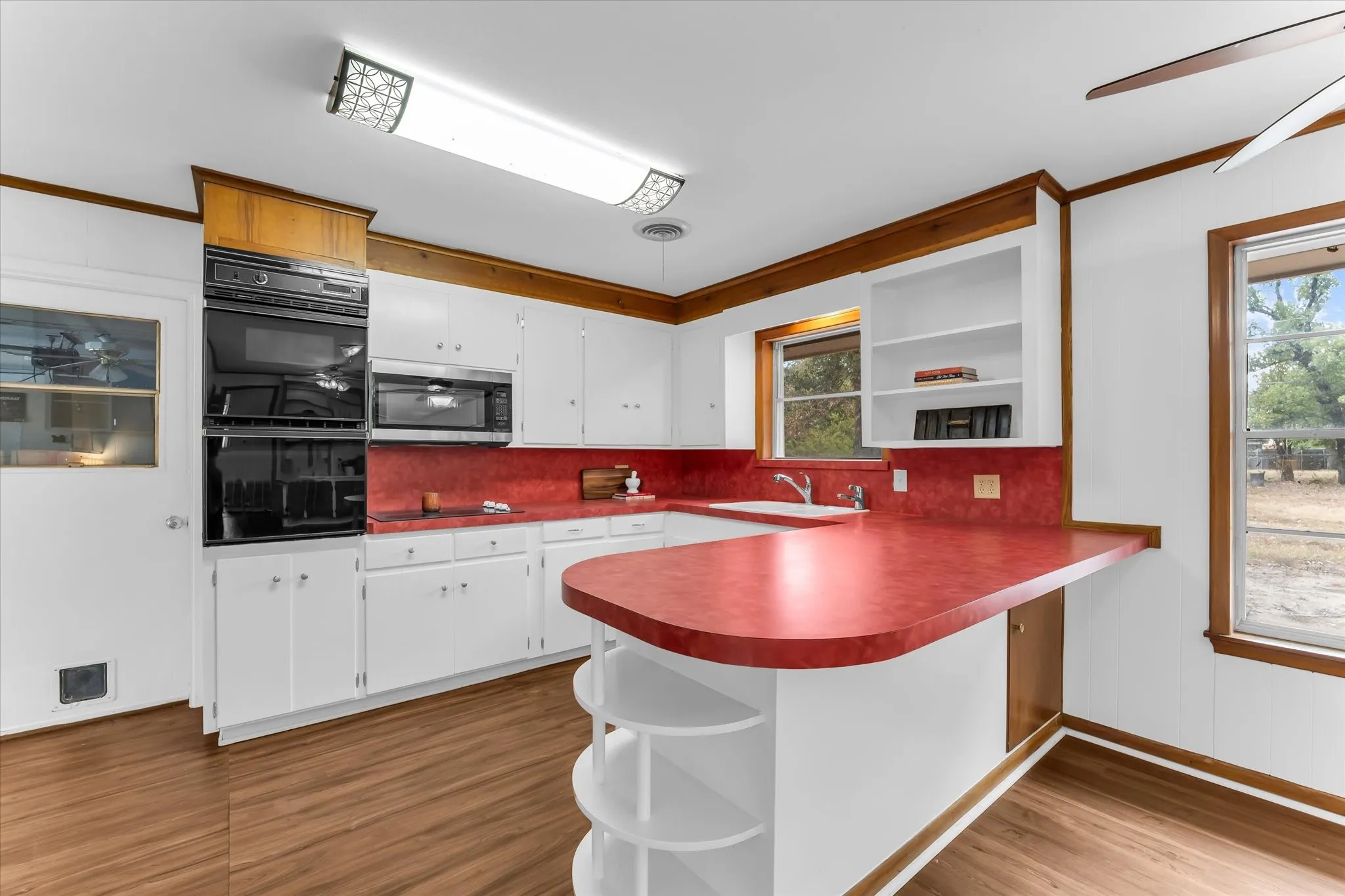 The kitchen features original high-quality cabinetry, updated appliances, and a breakfast bar. The kitchen is open to the family room.