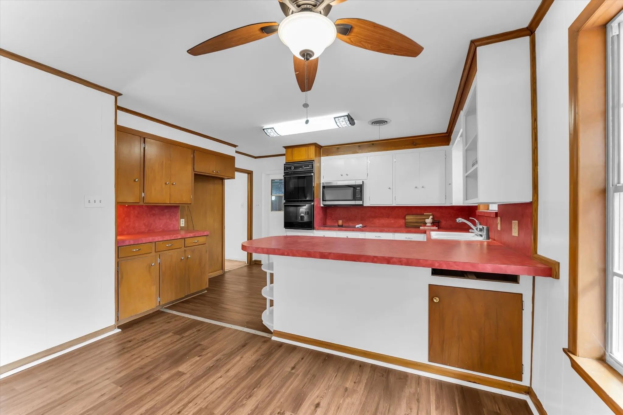 The kitchen features original high-quality cabinetry, updated appliances, and a breakfast bar. The kitchen is open to the family room.