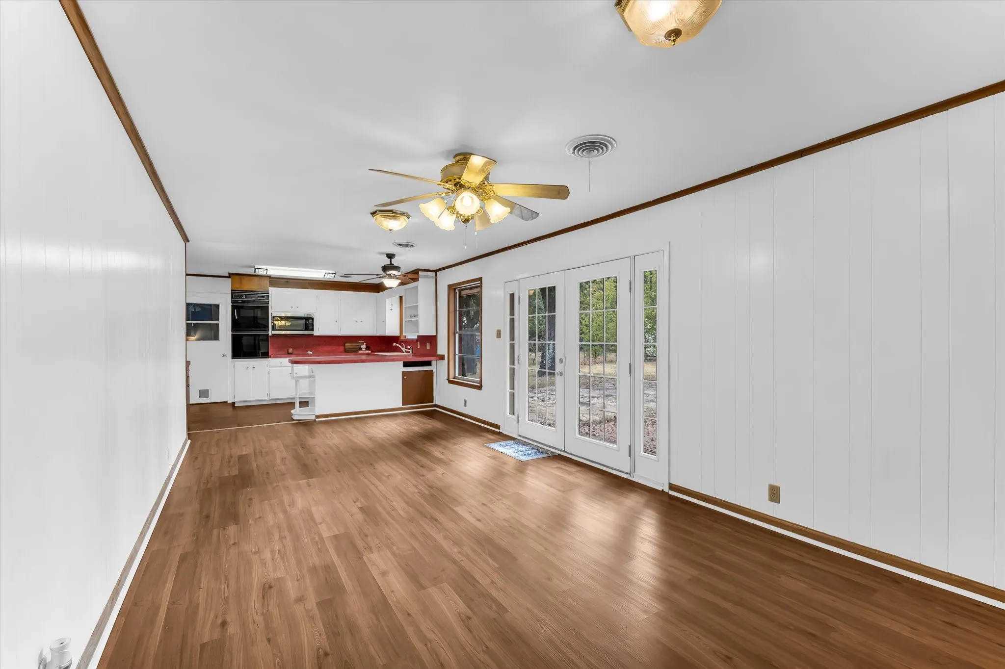 The family room is open to the kitchen and features French doors to the back yard.