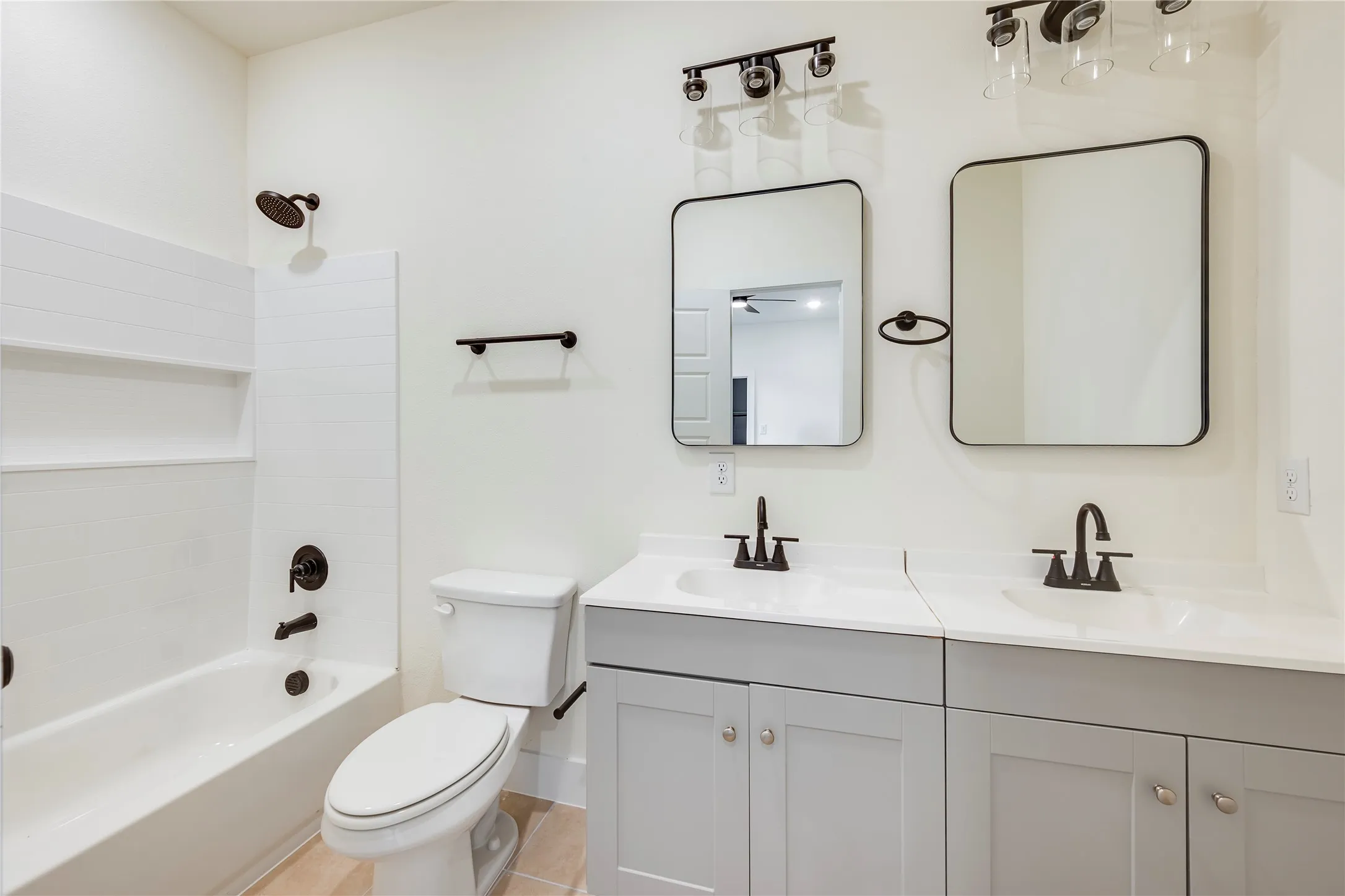 Dual vanity with light gray cabinetry, white countertops, and integrated sinks