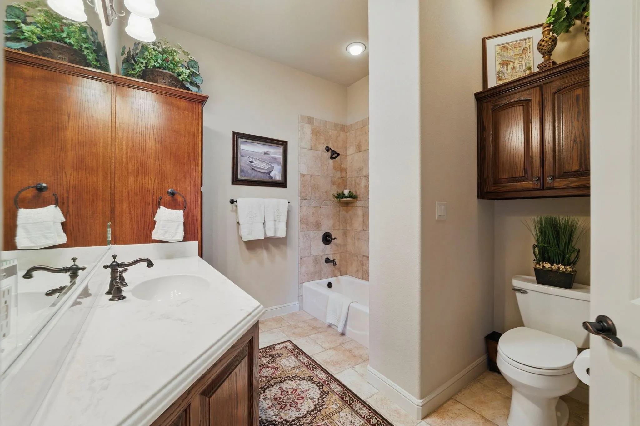 White vanity countertop with an undermount sink and oil-rubbed bronze faucet