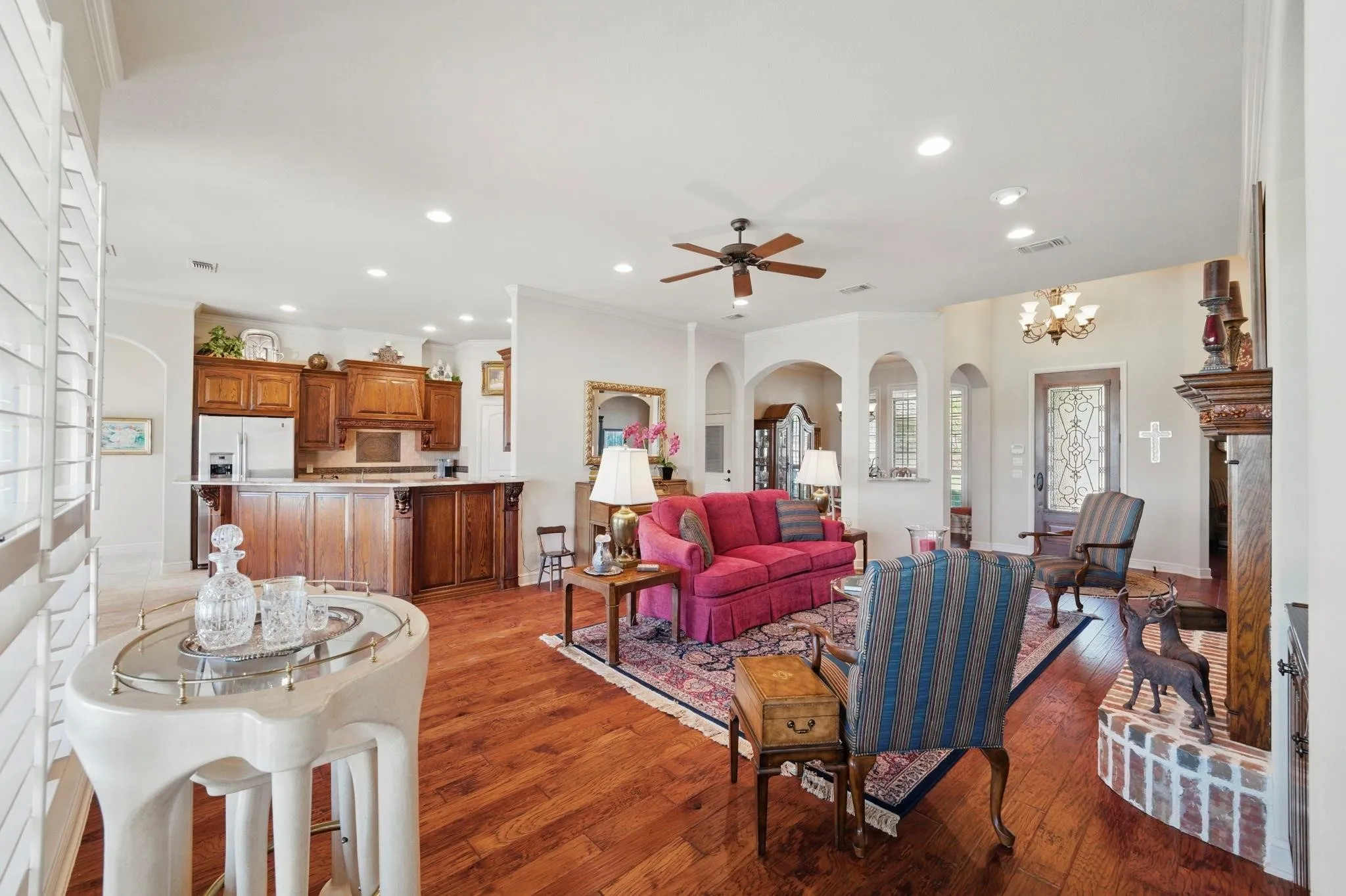 Wood-finish flooring throughout, featuring a kitchen with wood cabinetry and a breakfast bar