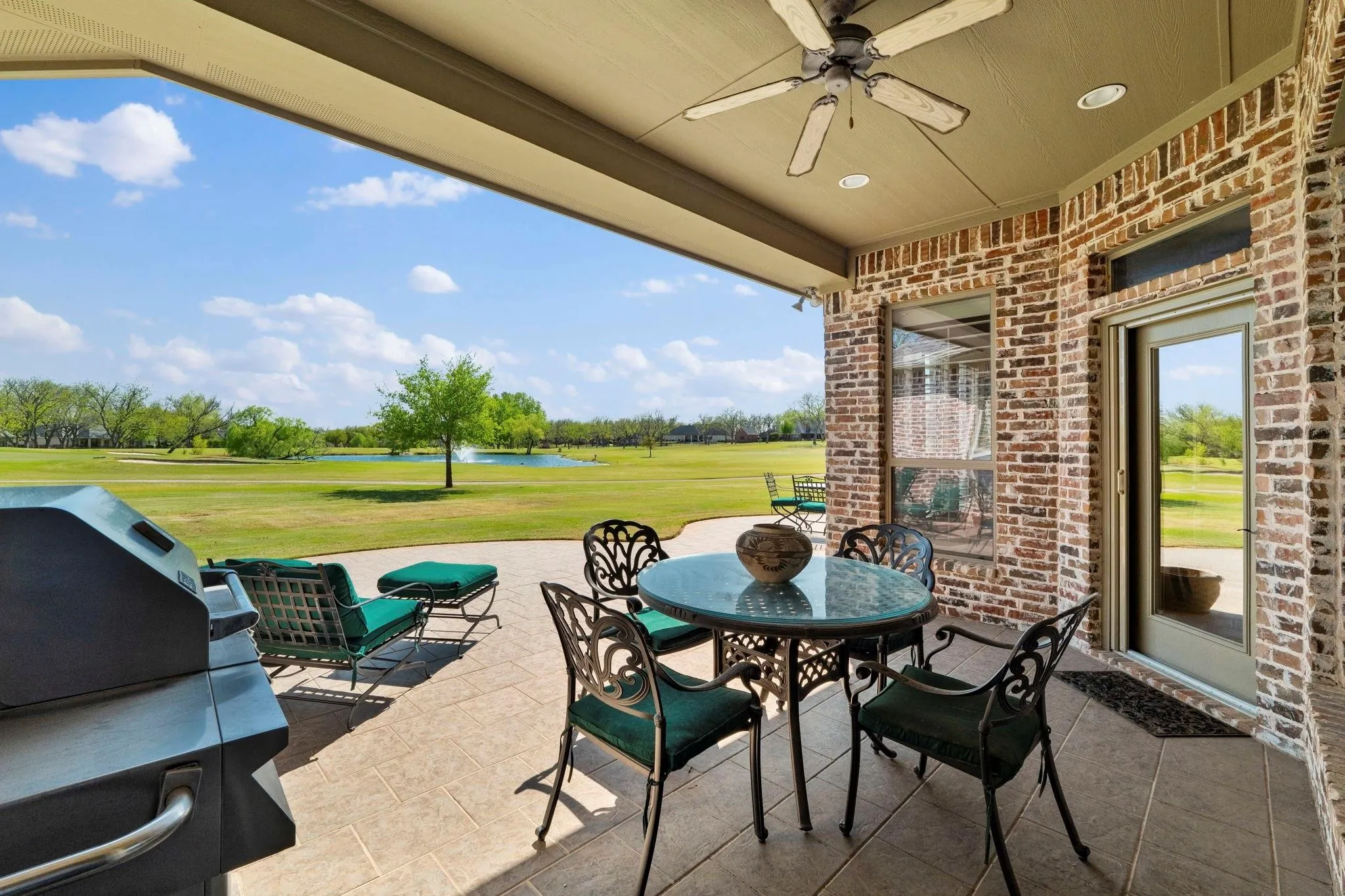 Covered patio featuring a ceiling fan, recessed lighting, and brick exterior