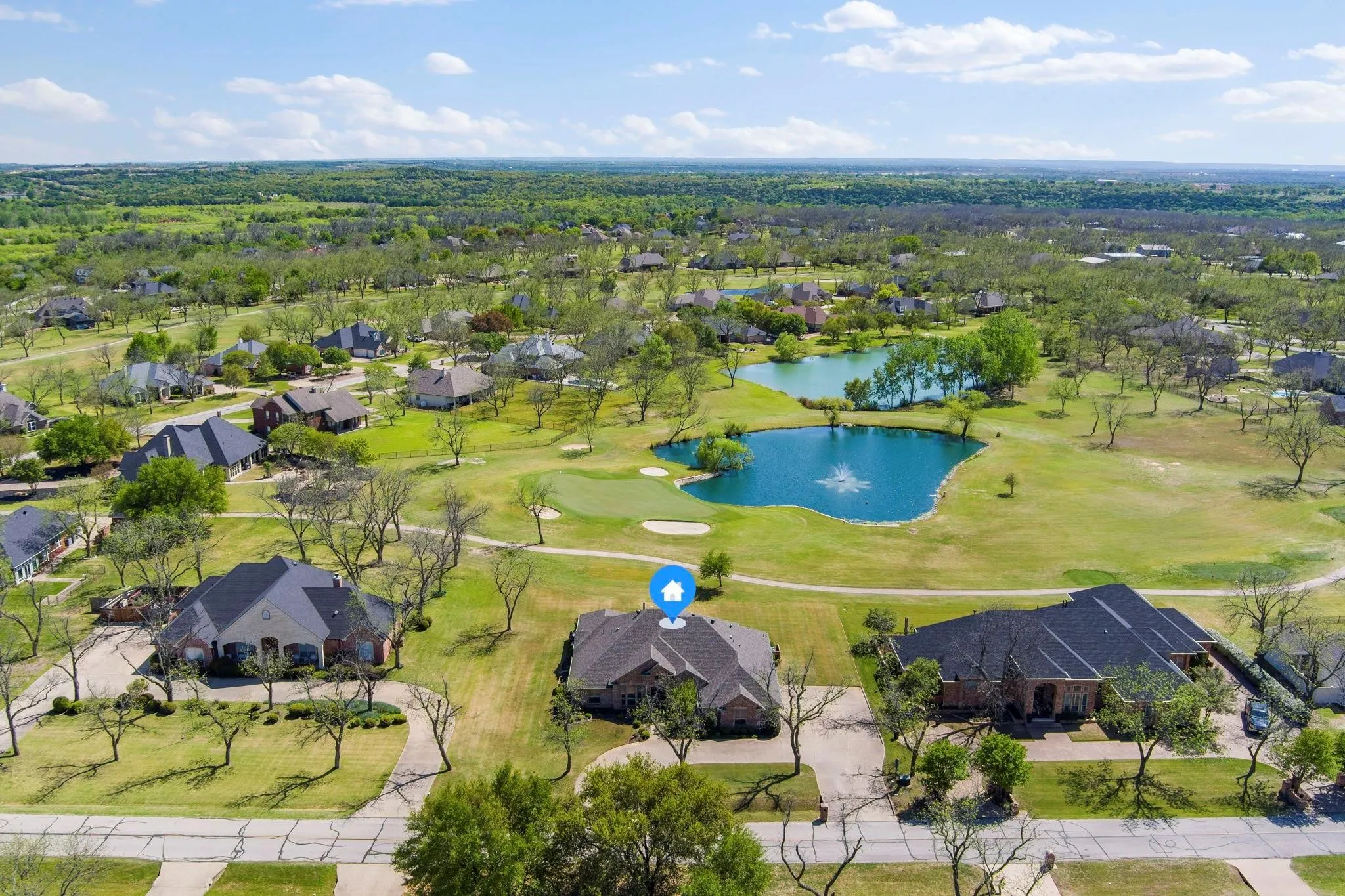Expansive residential community with green spaces and golf course access