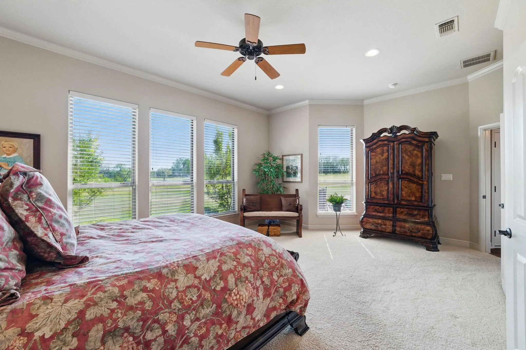 Carpeted flooring, vaulted ceiling, recessed lighting, ceiling fan, and multiple windows