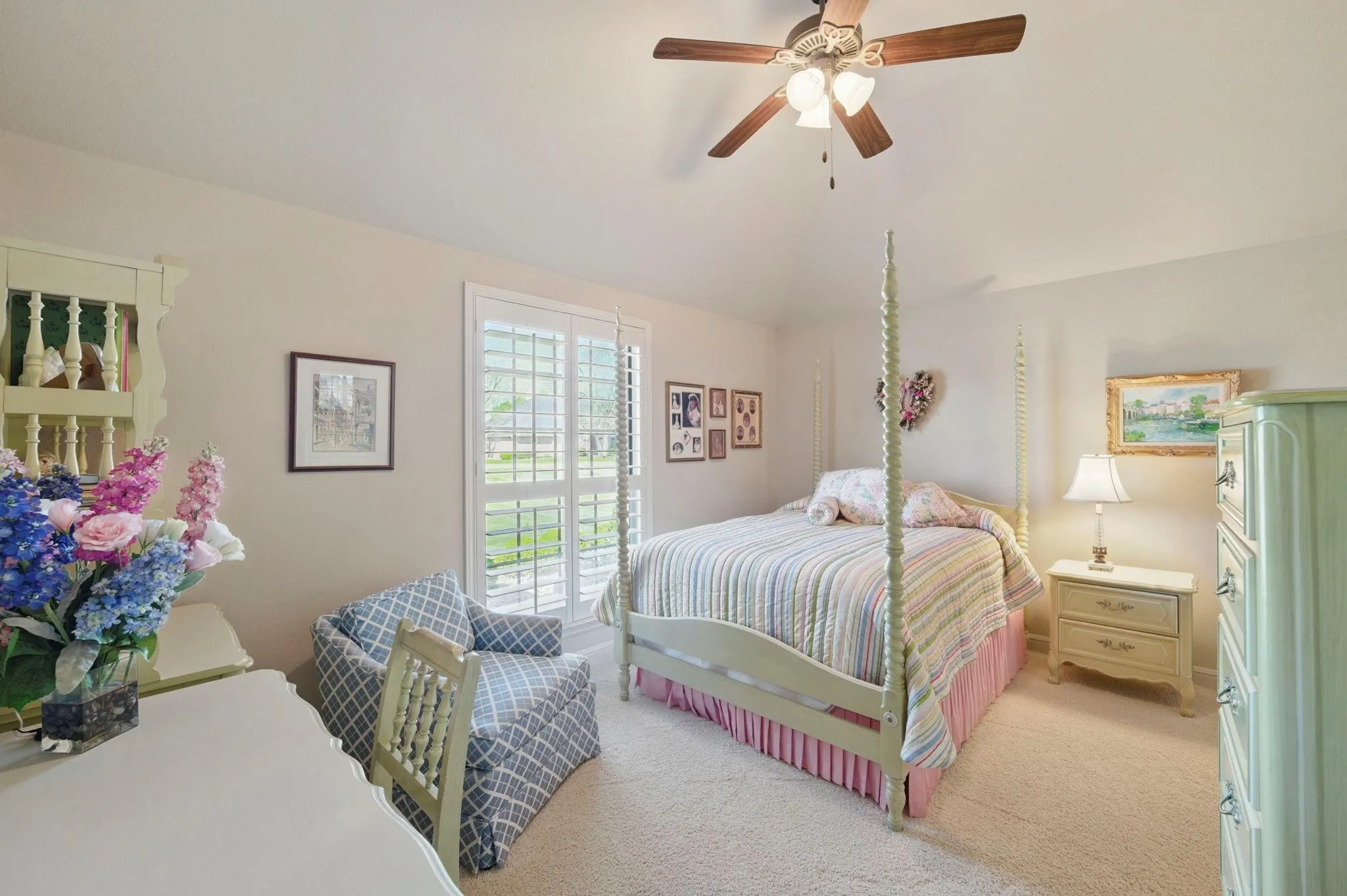 Vaulted ceiling with ceiling fan, wall-to-wall carpeting, and plantation shutters