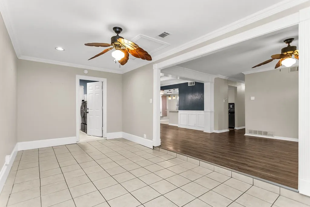 Tile flooring, wood-finish flooring, ceiling fans, crown molding, and recessed lighting