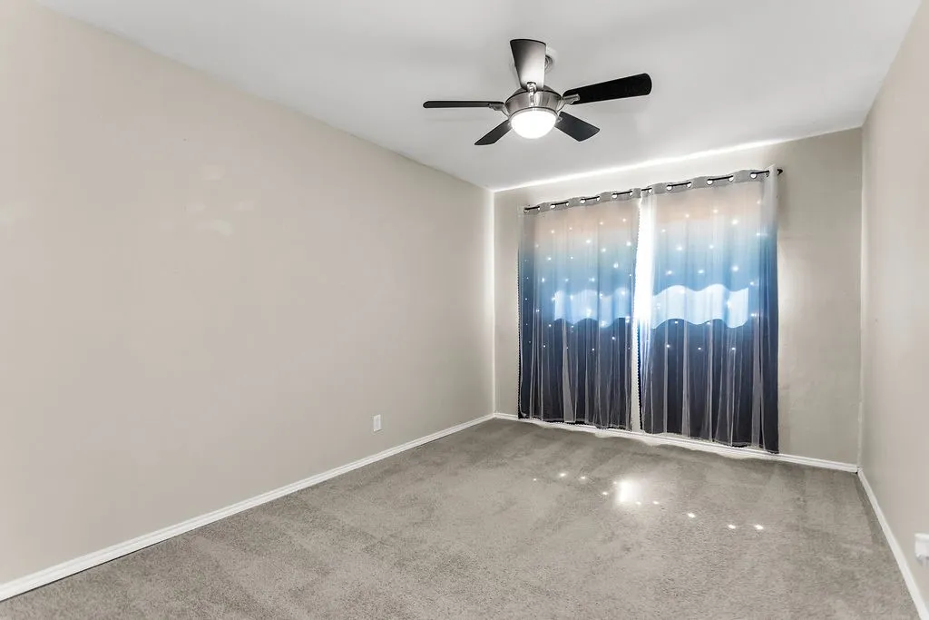 Neutral wall color and carpeted flooring
