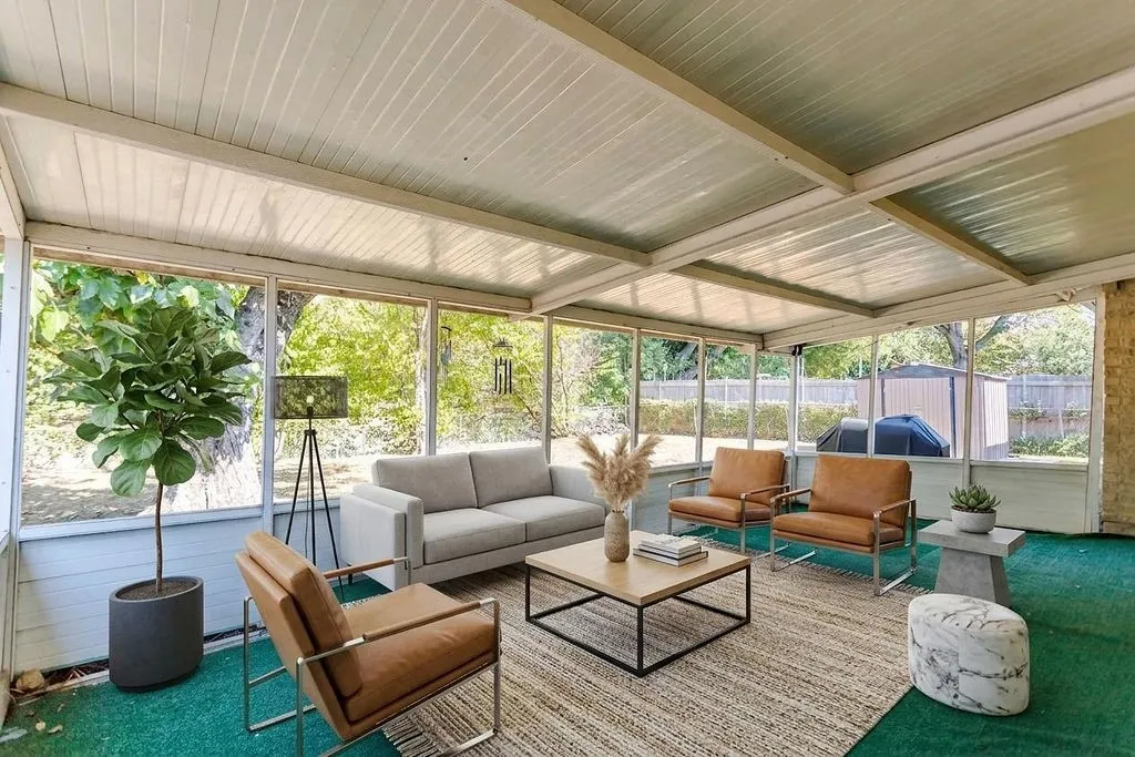 Enclosed patio with a paneled ceiling, numerous window panels, and wall-to-wall carpeting