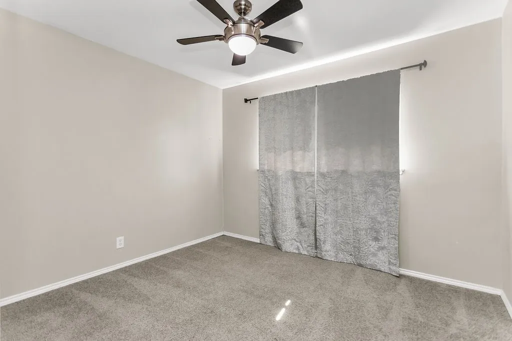 Neutral paint palette with carpeted flooring and white trim