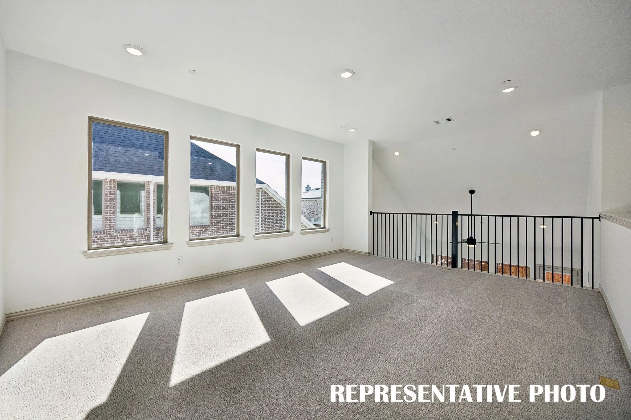 Spacious and flooded with natural light, this wonderful game room is the perfect place to host those big game day parties!  REPRESENTATIVE PHOTO
