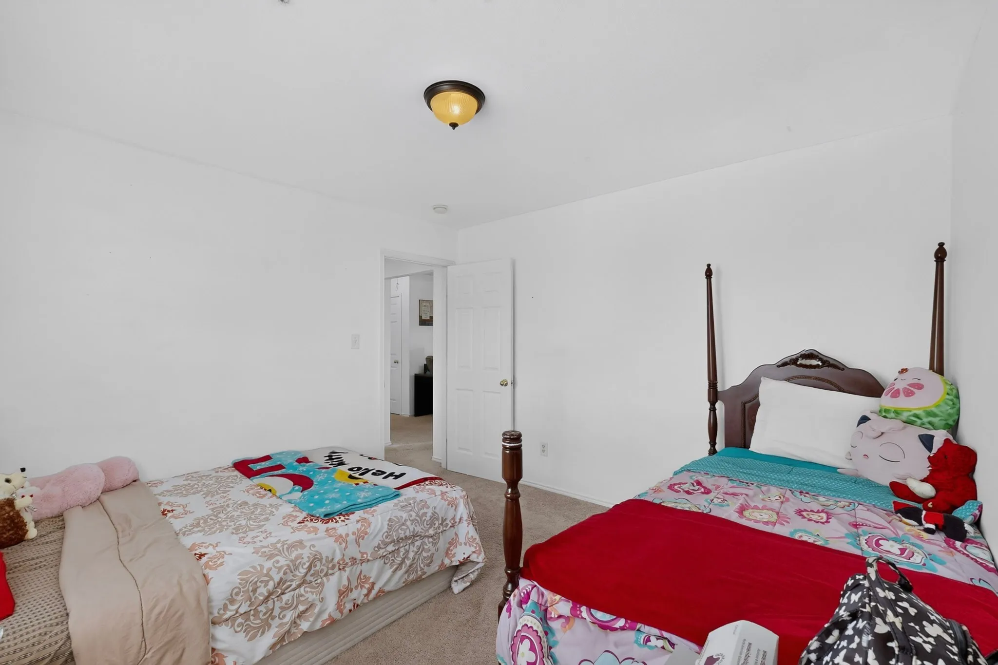 Recessed lighting, neutral wall tones, carpeted flooring, and a paneled interior door