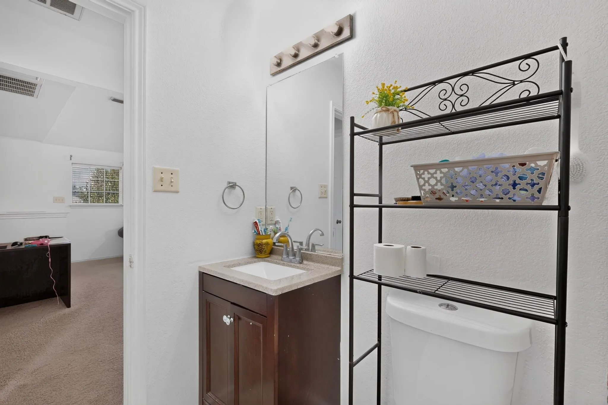 Brown wood-finish vanity with an integrated sink and light-colored countertop