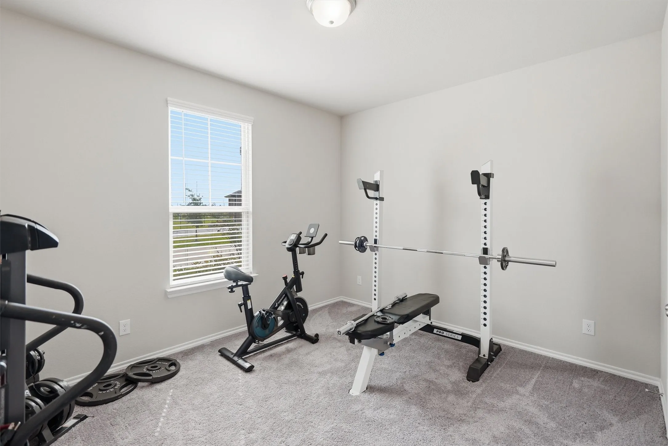 This bright and spacious secondary bedroom offers the ultimate flexibility, whether you need a dedicated home gym, a private office, or a traditional quest room.