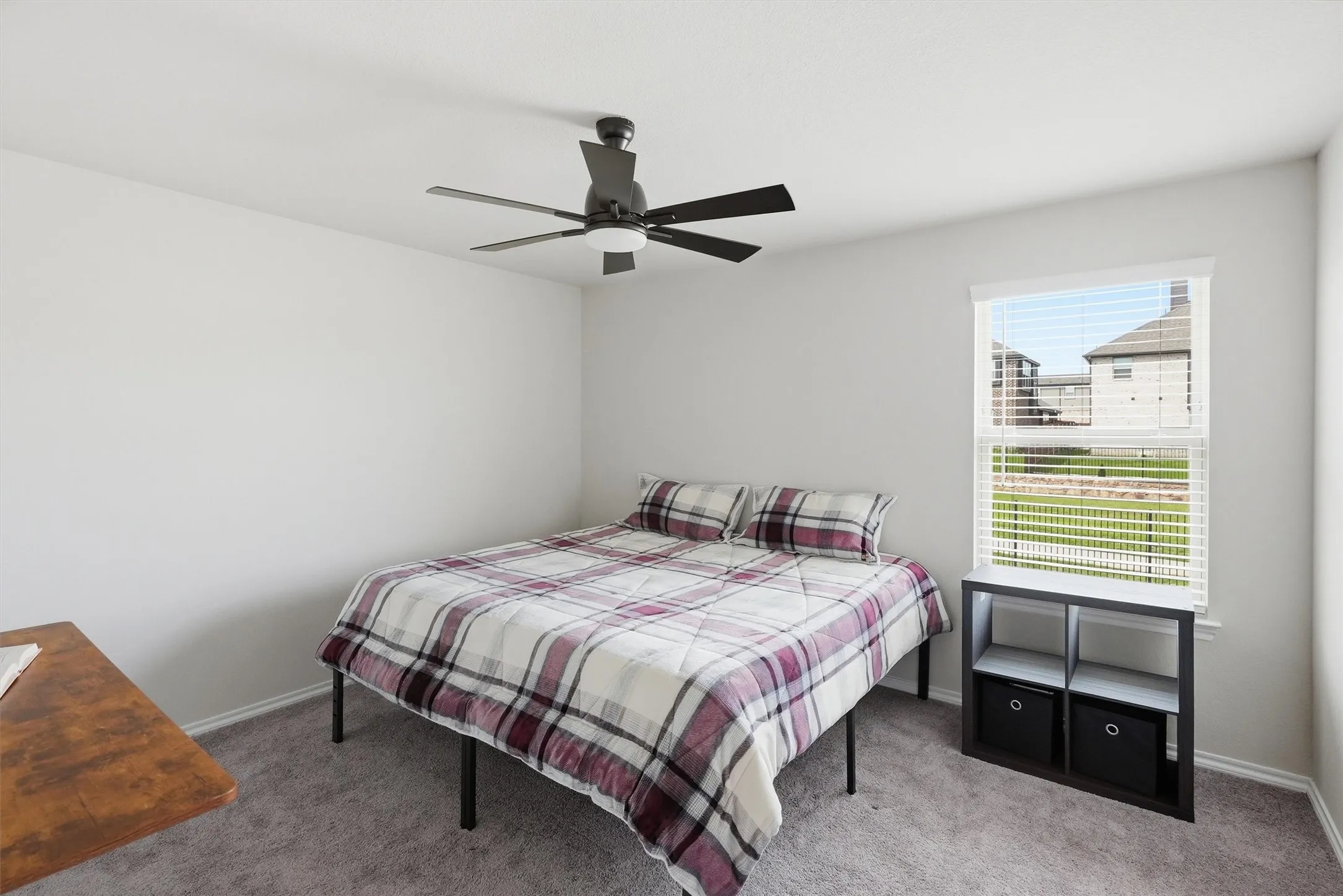 This secondary bedroom has a thoughtful layout that provides plenty of wall space for a desk or dresser, ensuring it meets all the practical needs of a growing family.